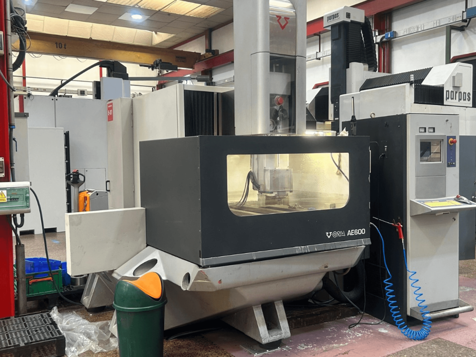 Die-sinking EDM machine ONA AE600 in operational setup, featuring a front view with visible control panel and work area.