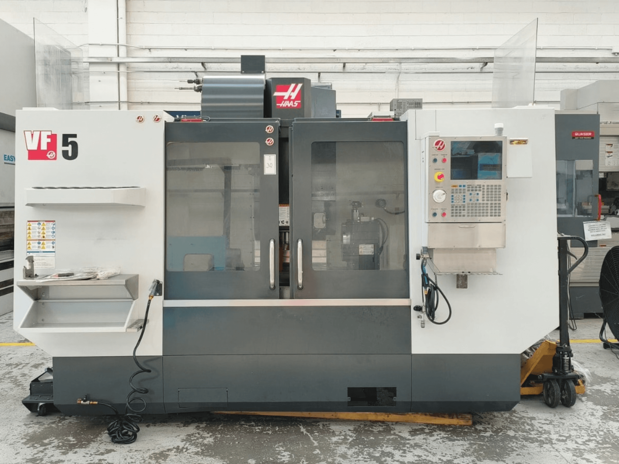 HAAS VF 5/40 vertical machining center front view, featuring control panel and glass doors.