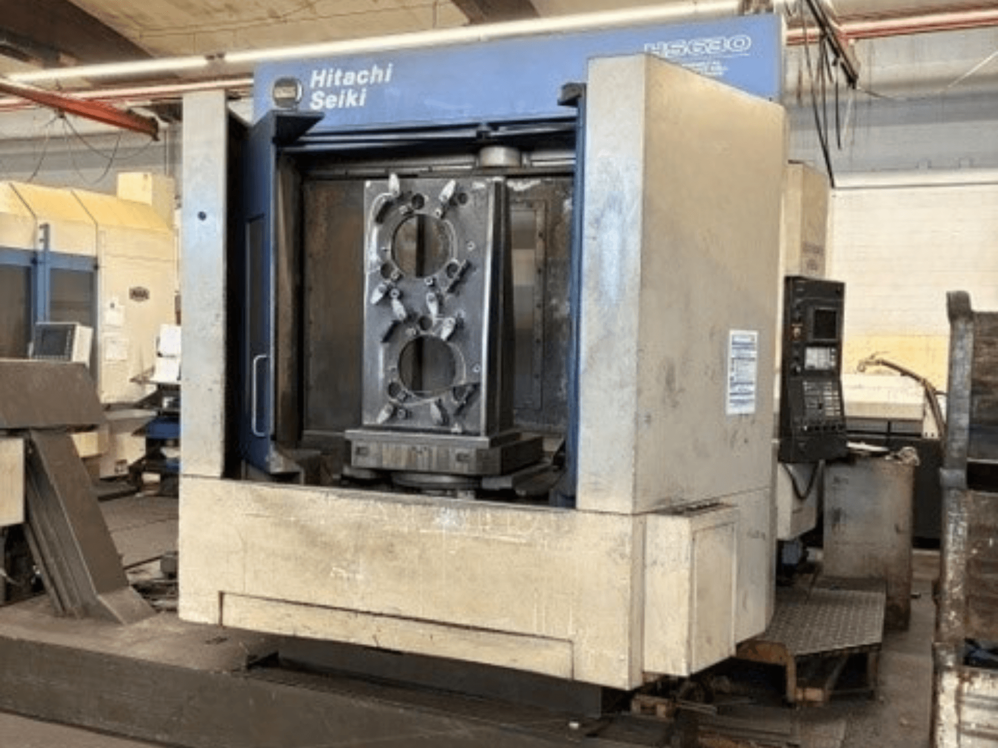Hitachi Seiki HS630 horizontal machining centre, front view showcasing a workpiece and control panel.
