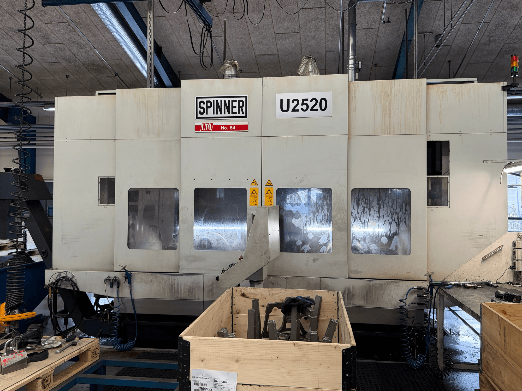 SPINNER U5-2520 vertical machining centre in a workshop, front view, showing control panel and work area with tools.