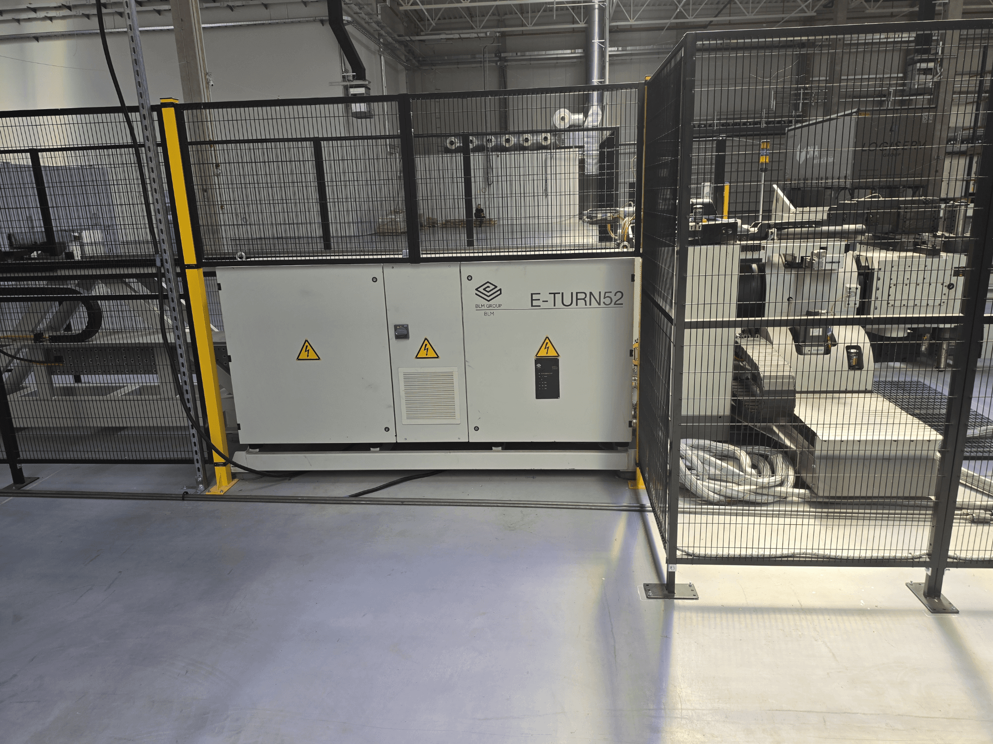 BLM E-TURN 52B die bending machine in a side view, featuring safety enclosures and visible machine controls.