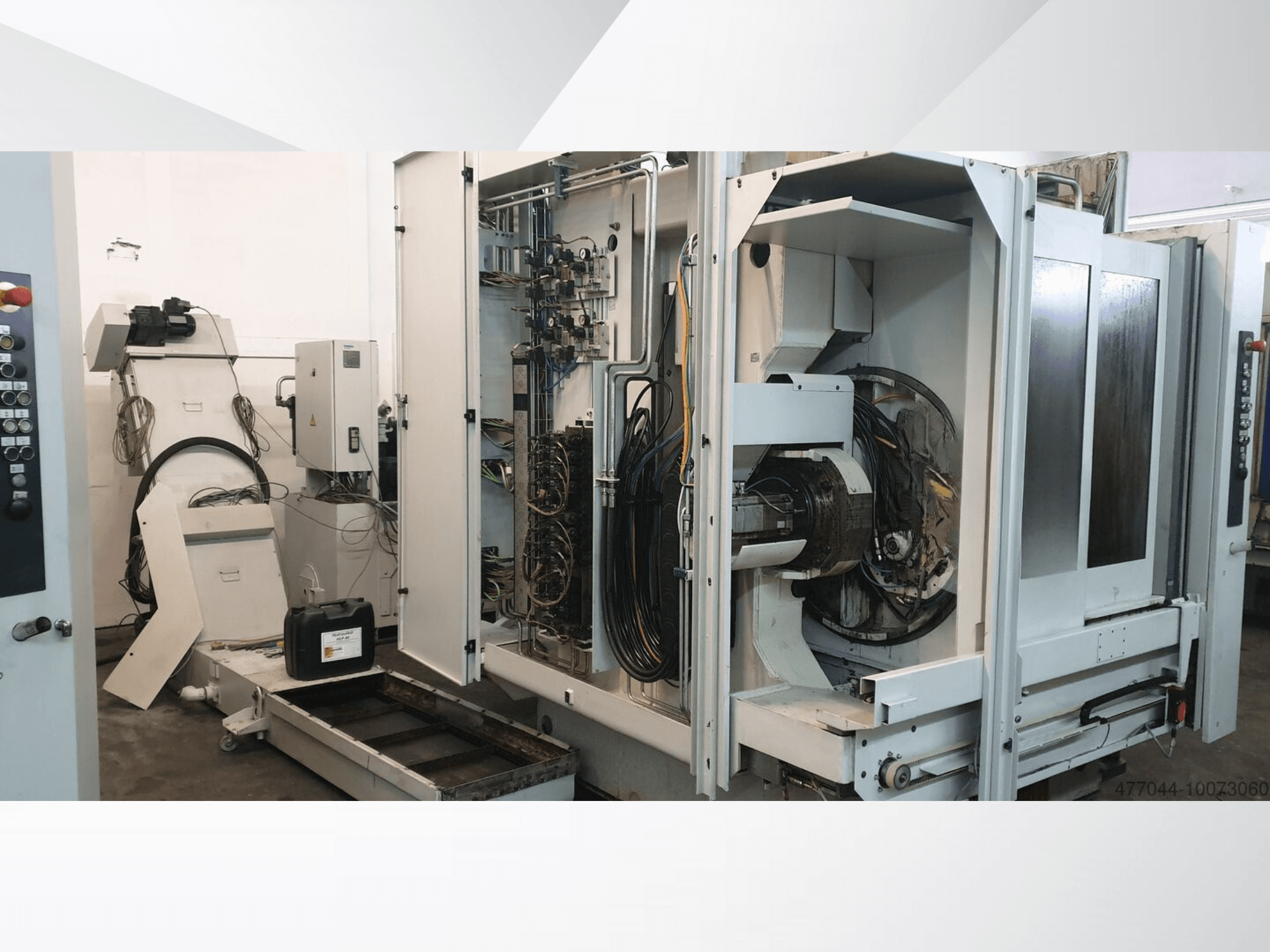 Industrial machinery featuring exposed wiring, control panel, and mechanical components; side view of a complex machine.