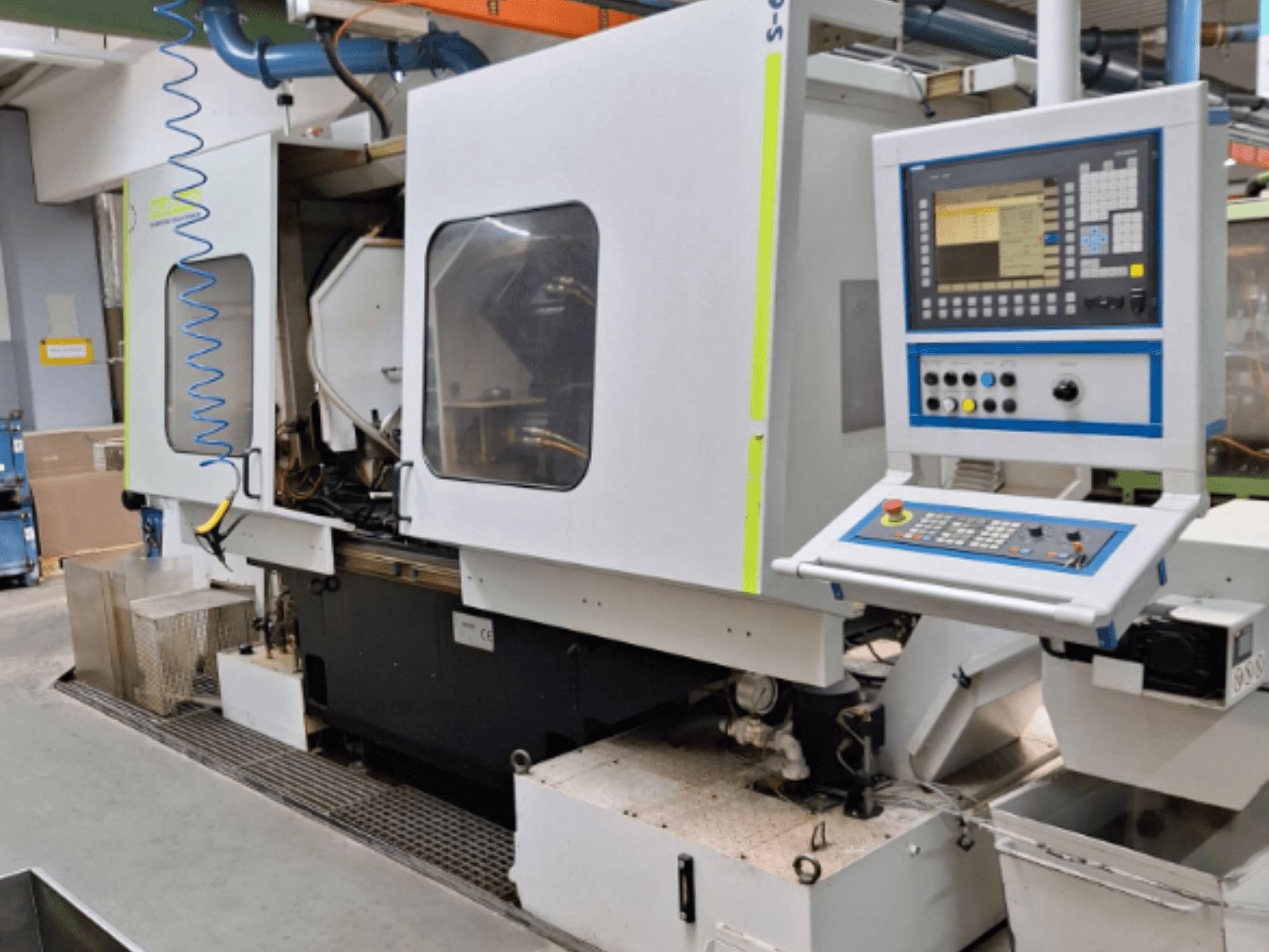 Industrial milling machine with a control panel, side view, featuring dual chambers and visible pipeline connections.