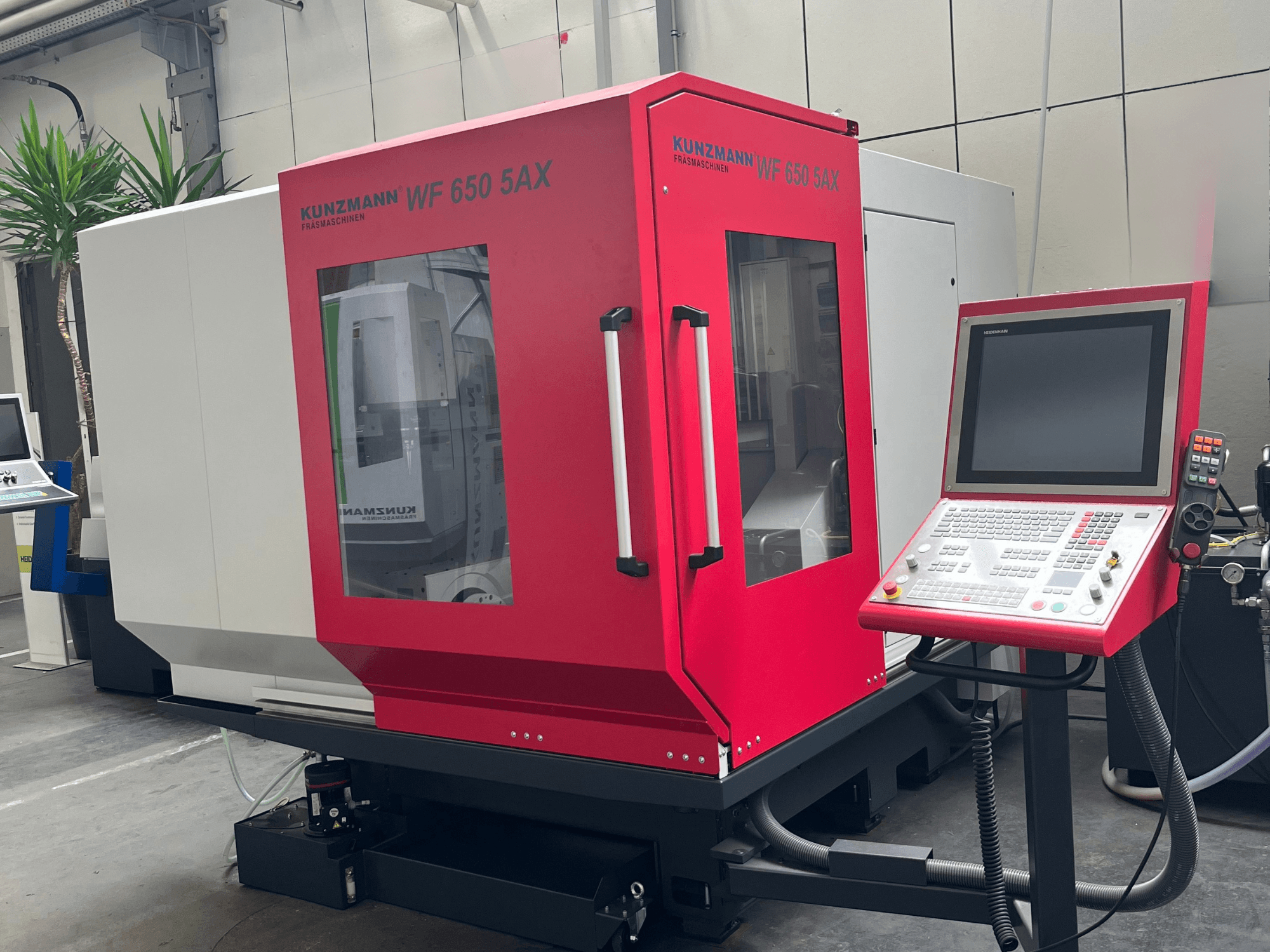 KUNZMANN WF 650 5AX vertical machining center in red, front view with control panel and touch screen, located in a workshop.