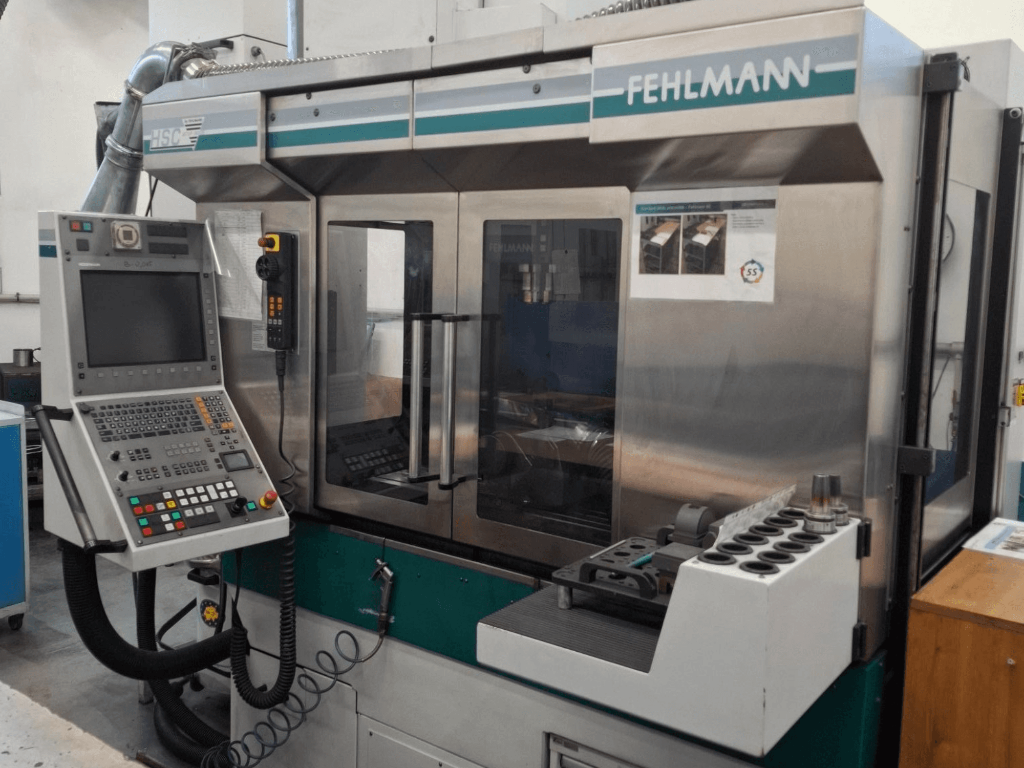 Fehlmann HSC 20 CNC machine, front view, featuring control panel, metal casing, and tool holder with multiple slots.