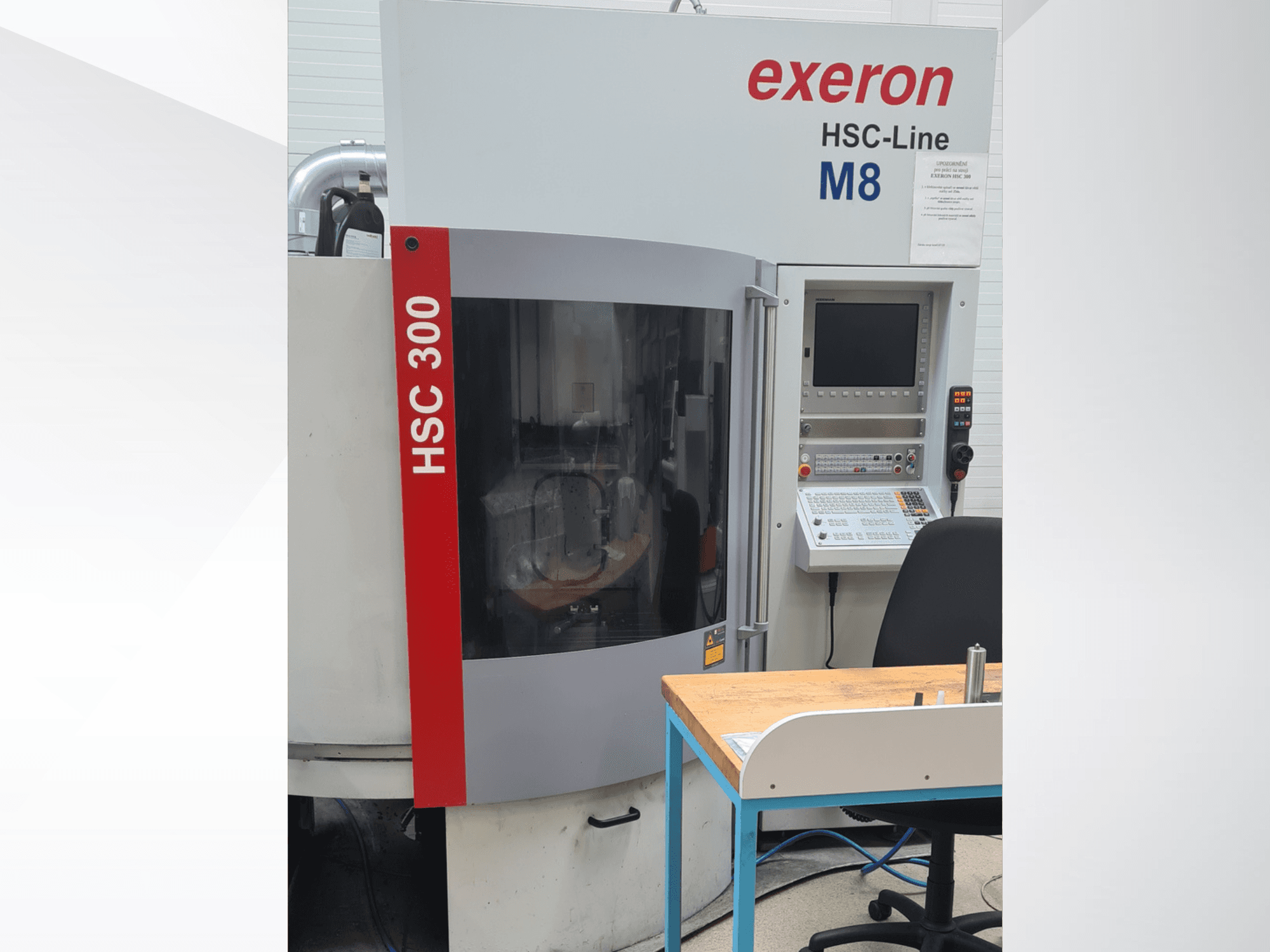 Exeron HSC 300/3 vertical machining center, front view, with control panel and worktable visible.