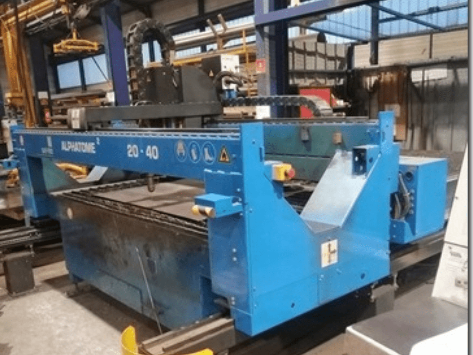 Blue ALPHATOME 20-40 CNC machine, front view, with cutting area and control panel visible, designed for precision manufacturing.