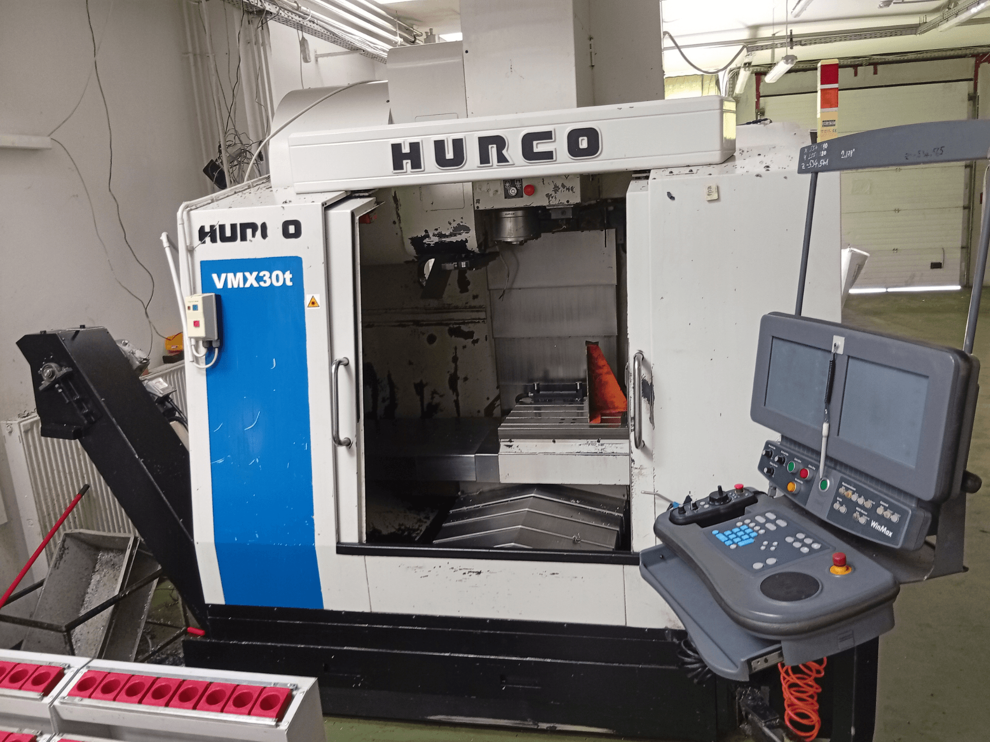 Hurco VMX 30T vertical machining center, front view, featuring control panel and spindle area with visible worktable.