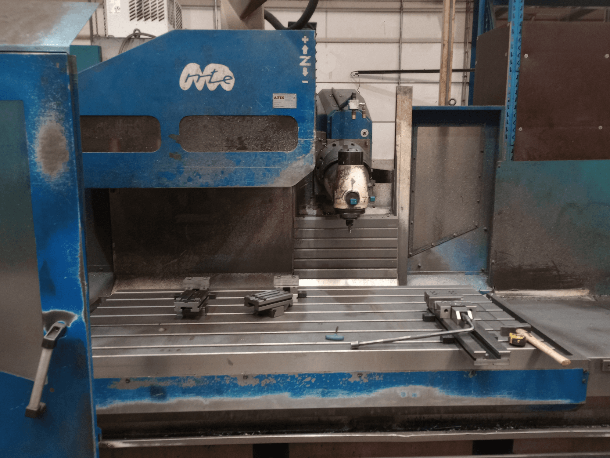 MTE BF 2200 bed type milling machine, front view, showing the work table with fixtures and cutting head.