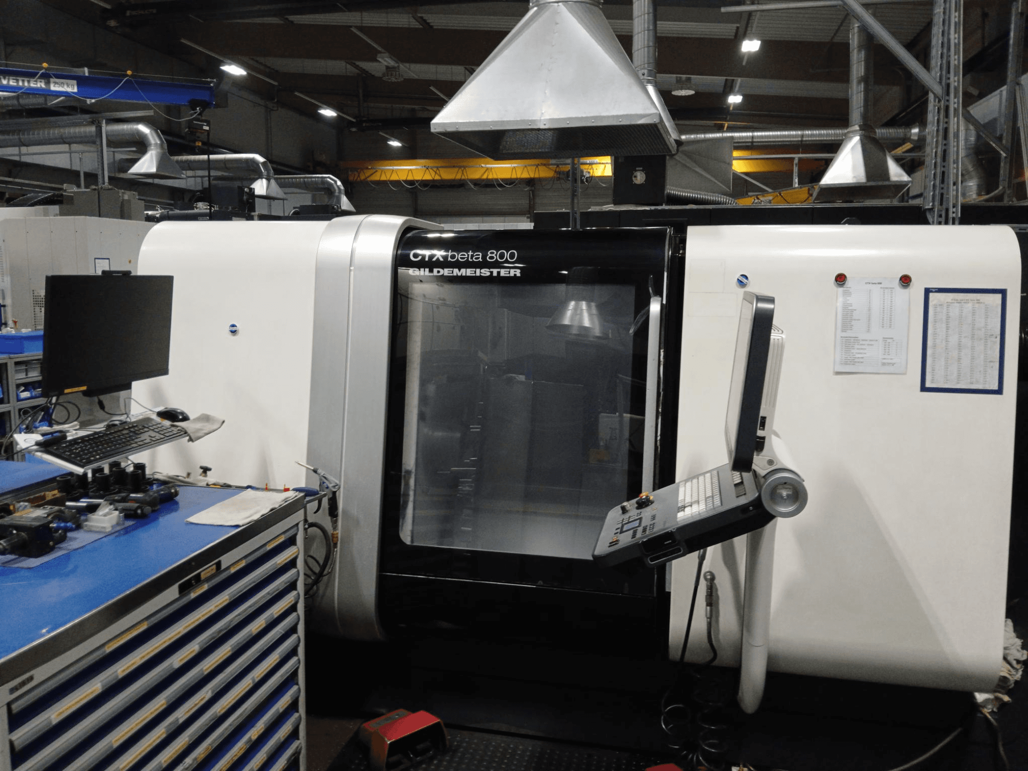 Horizontal turning machine DMG CTX beta 800, front view with control panel and monitor beside a workstation.