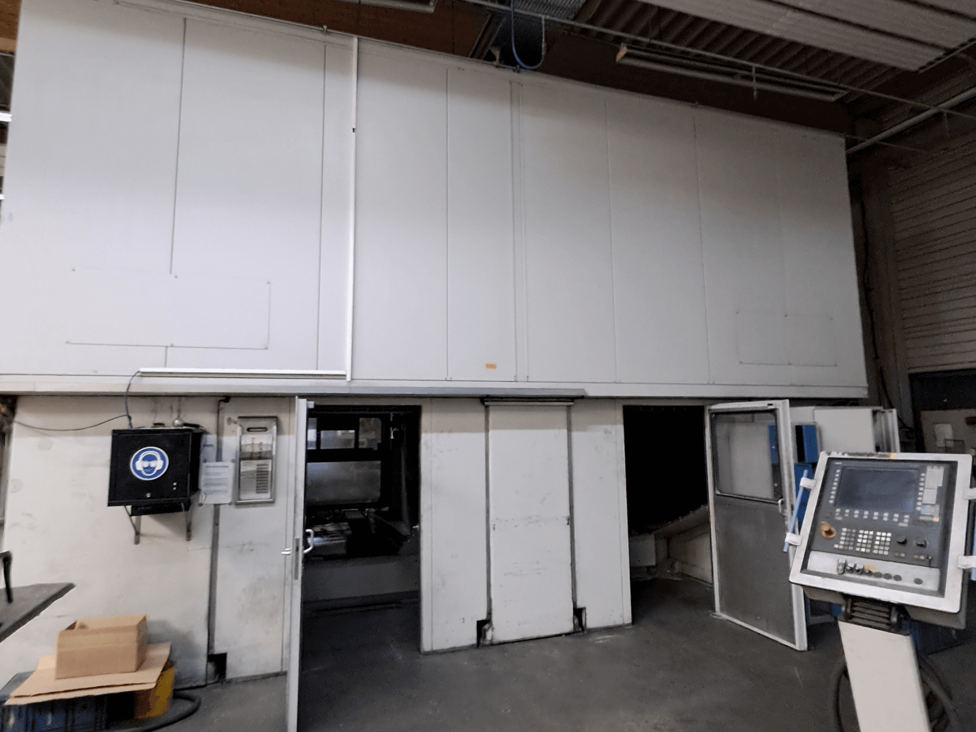 Gantry milling machine MAKA Moving Beam 840D, front view with open doors revealing the interior and control panel visible.