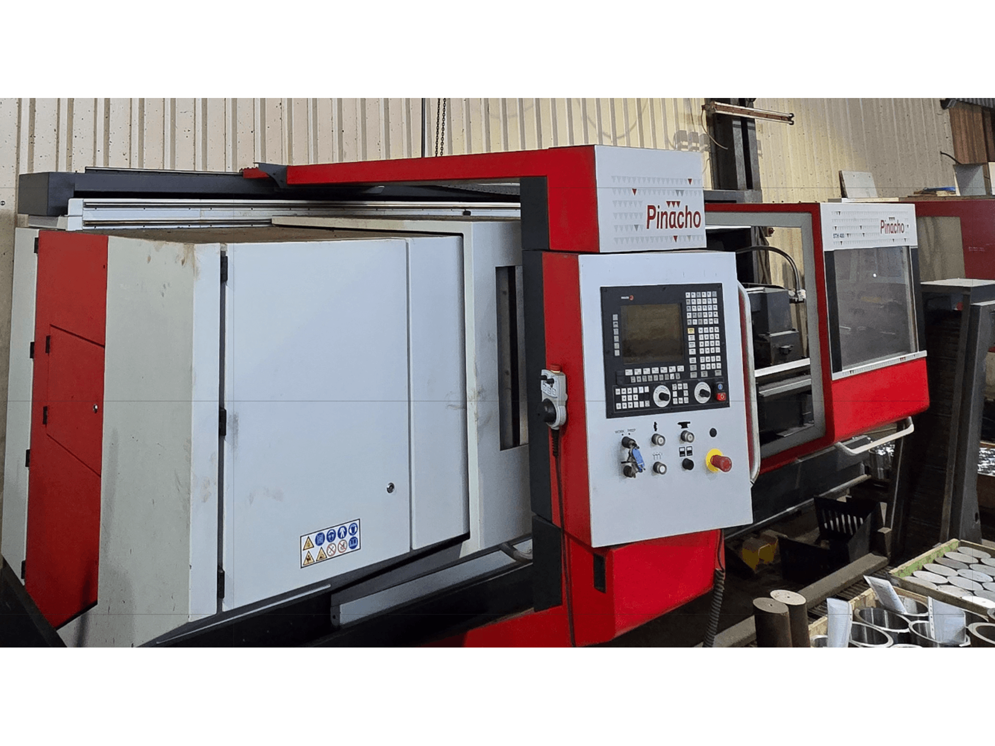 Pinacho STH 400-105×3000 horizontal turning machine, front view, showcasing control panel and red accents.