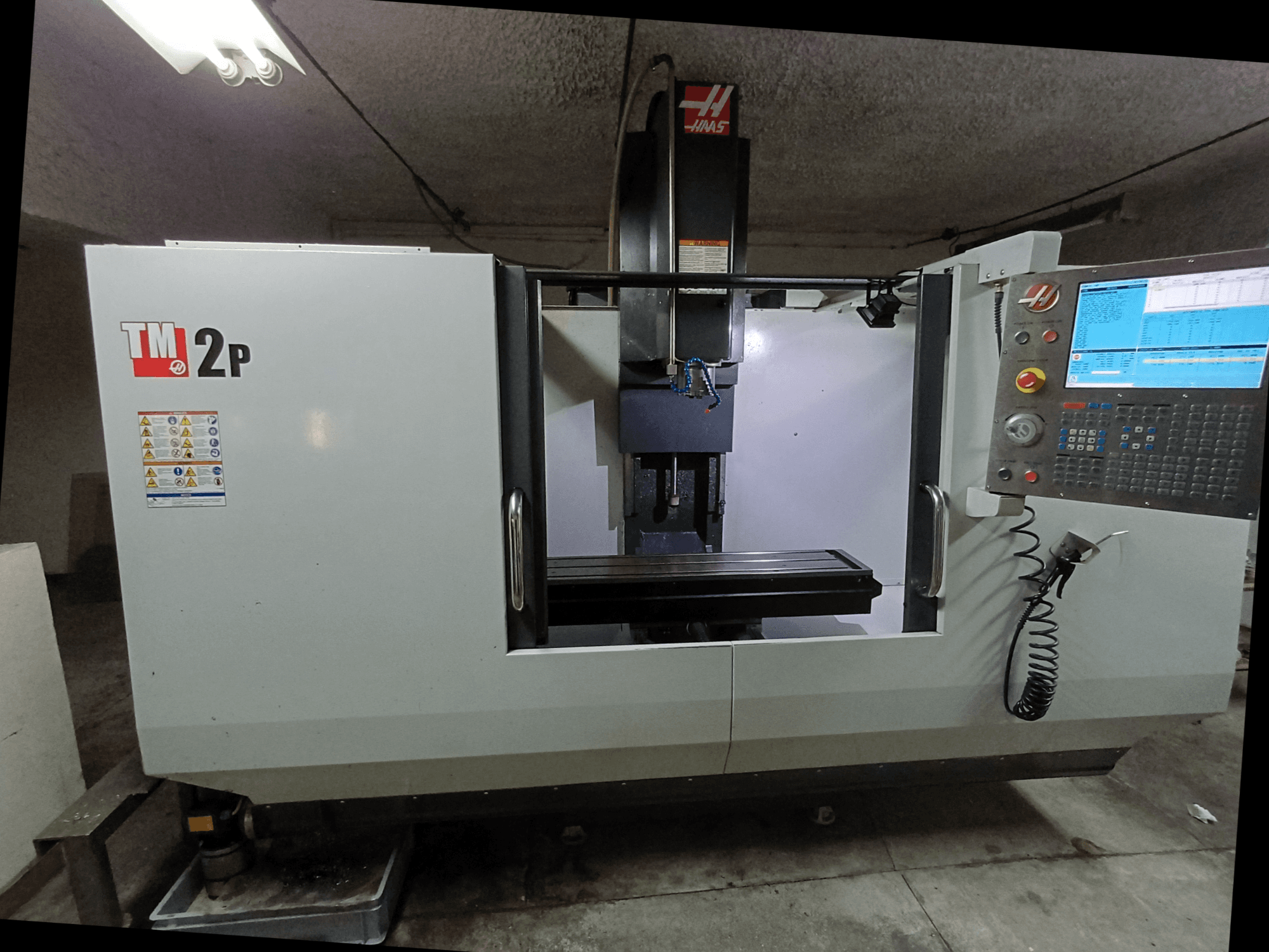 HAAS TM-2P Vertical Machining Centre, front view, showing control panel, spindle head, and machine bed.
