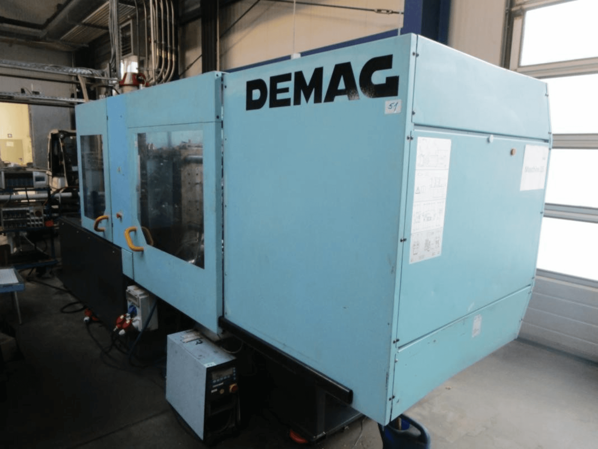 Front view of a DEMAG Ergotech 150-610 Viva hydraulic injection moulding machine, featuring visible control panel and handles.