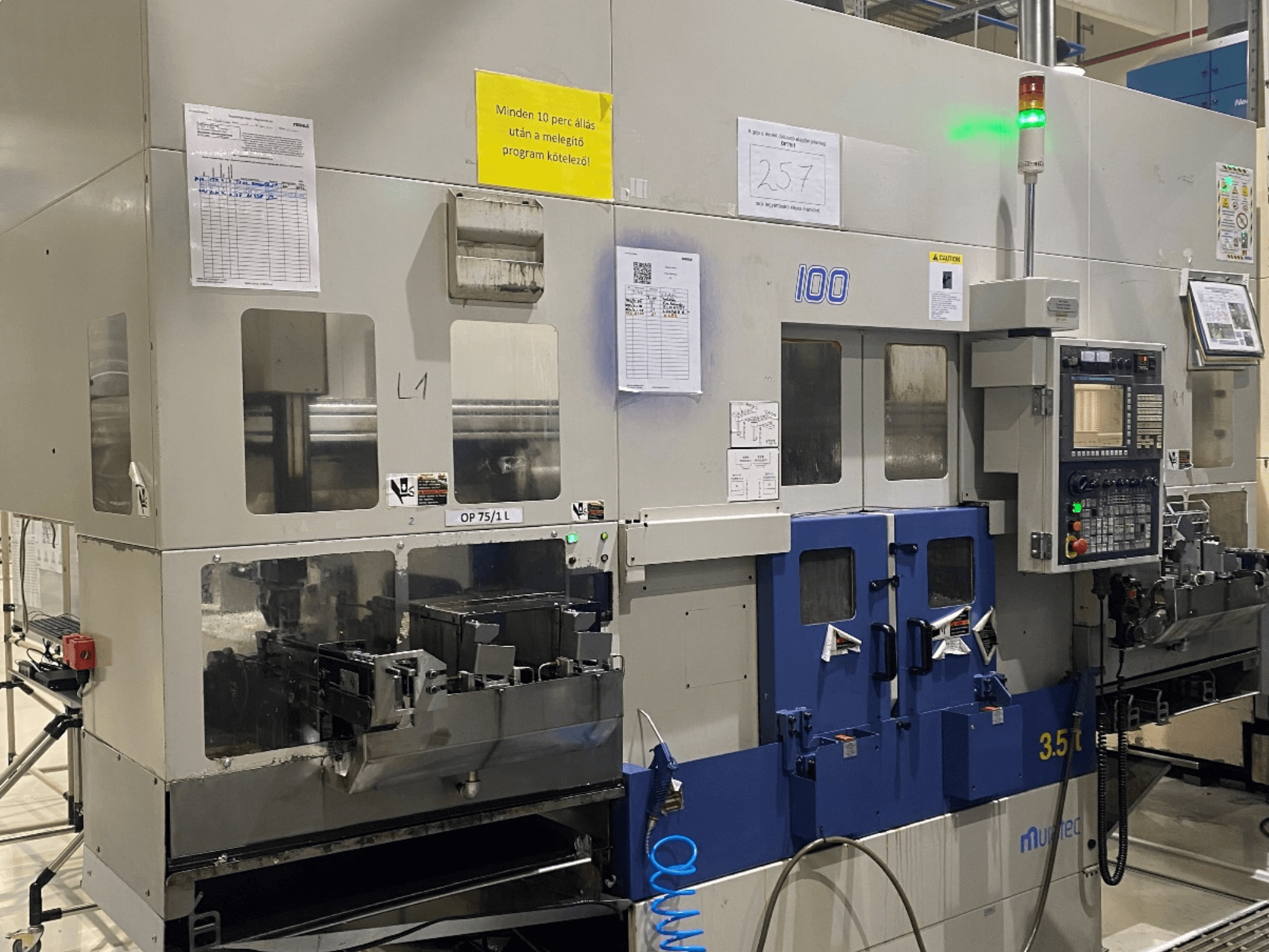 MURATA MW100 horizontal turning machine in a factory setting, front view showing control panel and operational details.
