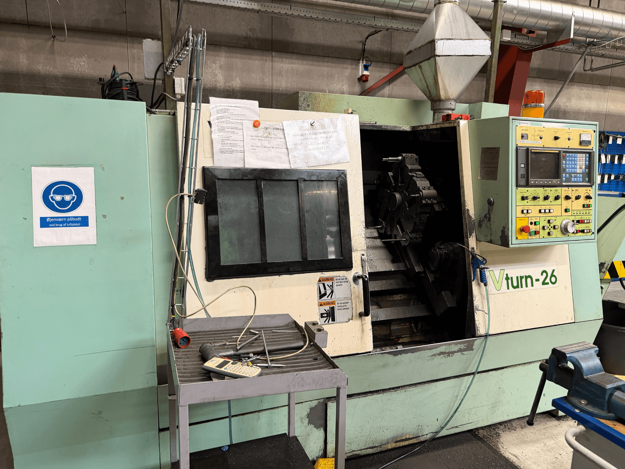 Front view of VICTORY VTurn-26 horizontal turning machine with control panel, work area, and safety signage visible.