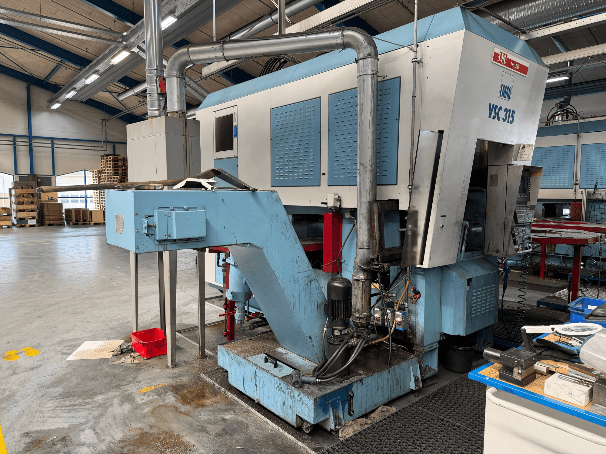 Vertical Turning Machine EMAG VSC 315 from side view, showing control panel, coolant system, and machinery structure.