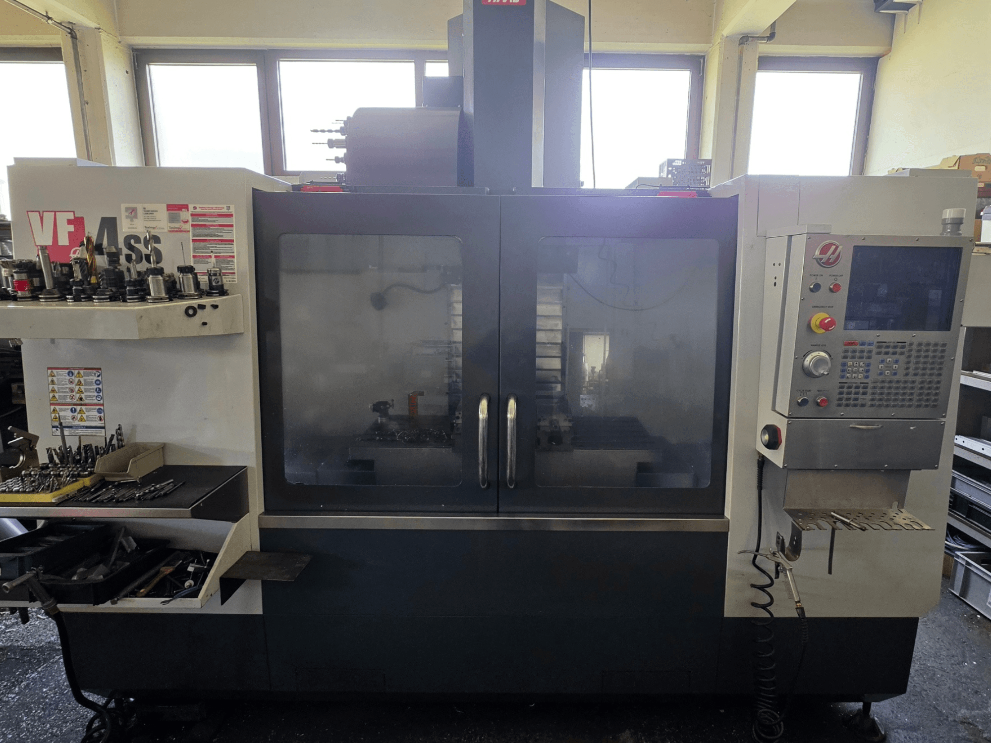 HAAS VF 34SS vertical machining center front view, showcasing control panel and tool storage area.