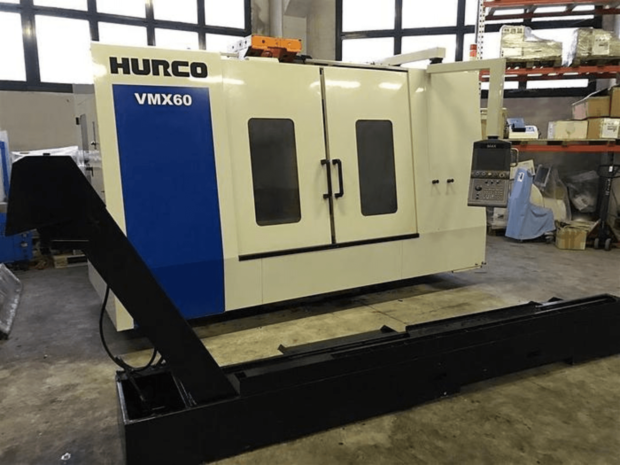 HURCO VMX60 CNC machine in a workshop, front view, featuring a control panel and attached black support rail.