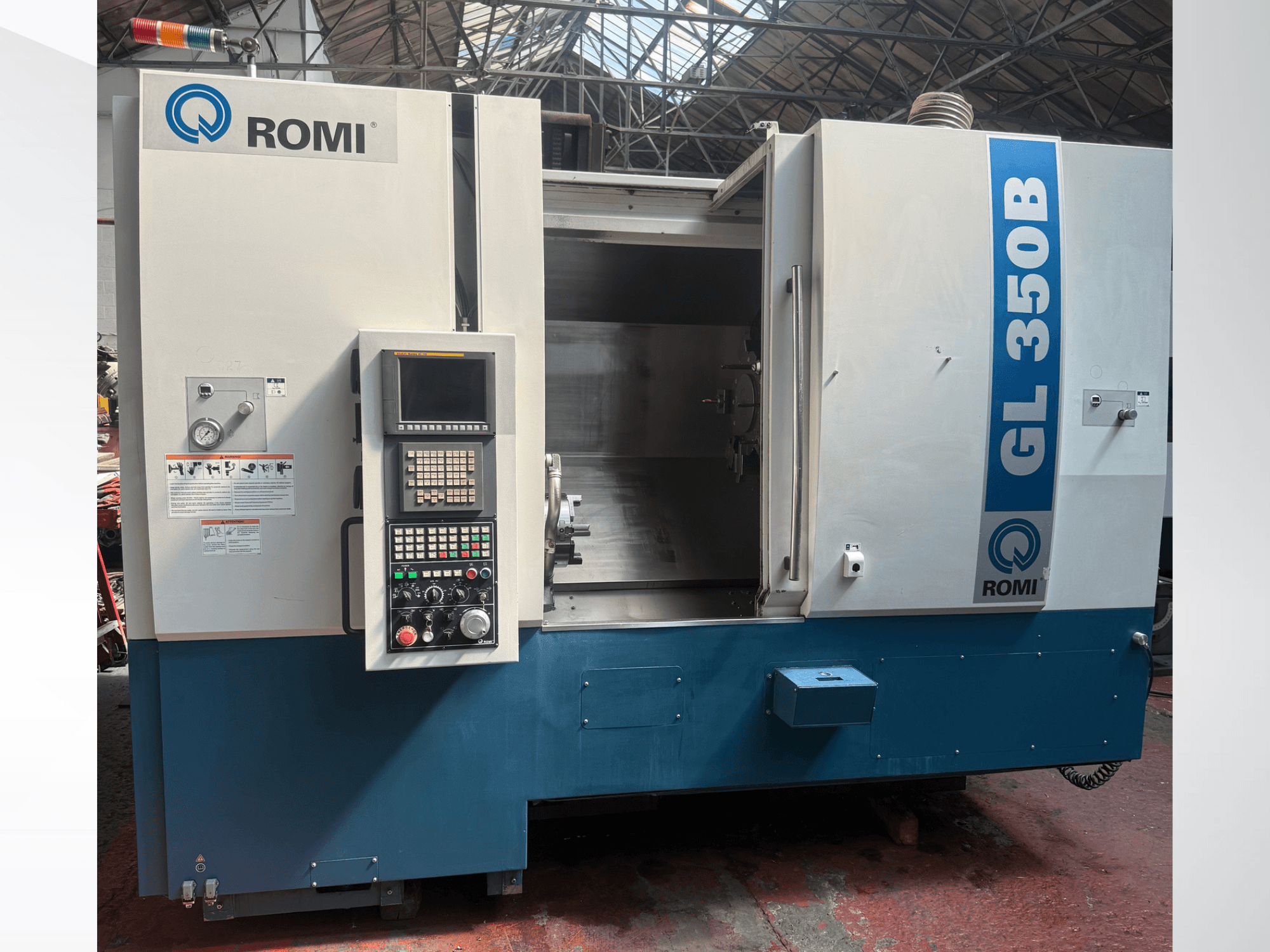 Front view of Romi GL 350B horizontal turning machine, showcasing control panel and open work area.