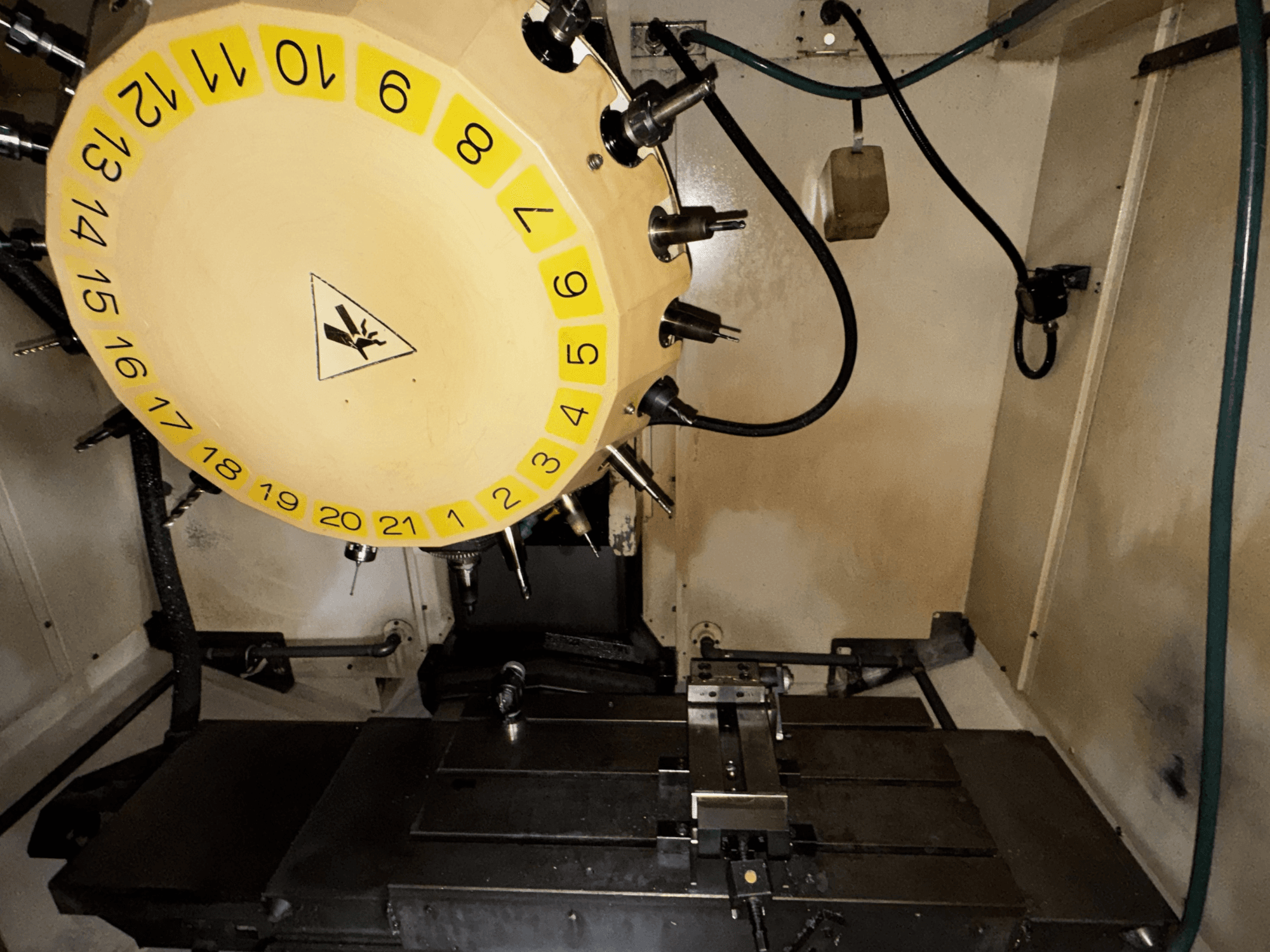 FANUC Robodrill alpha-T21iFL vertical machining center interior view with tool carousel and machining table visible.