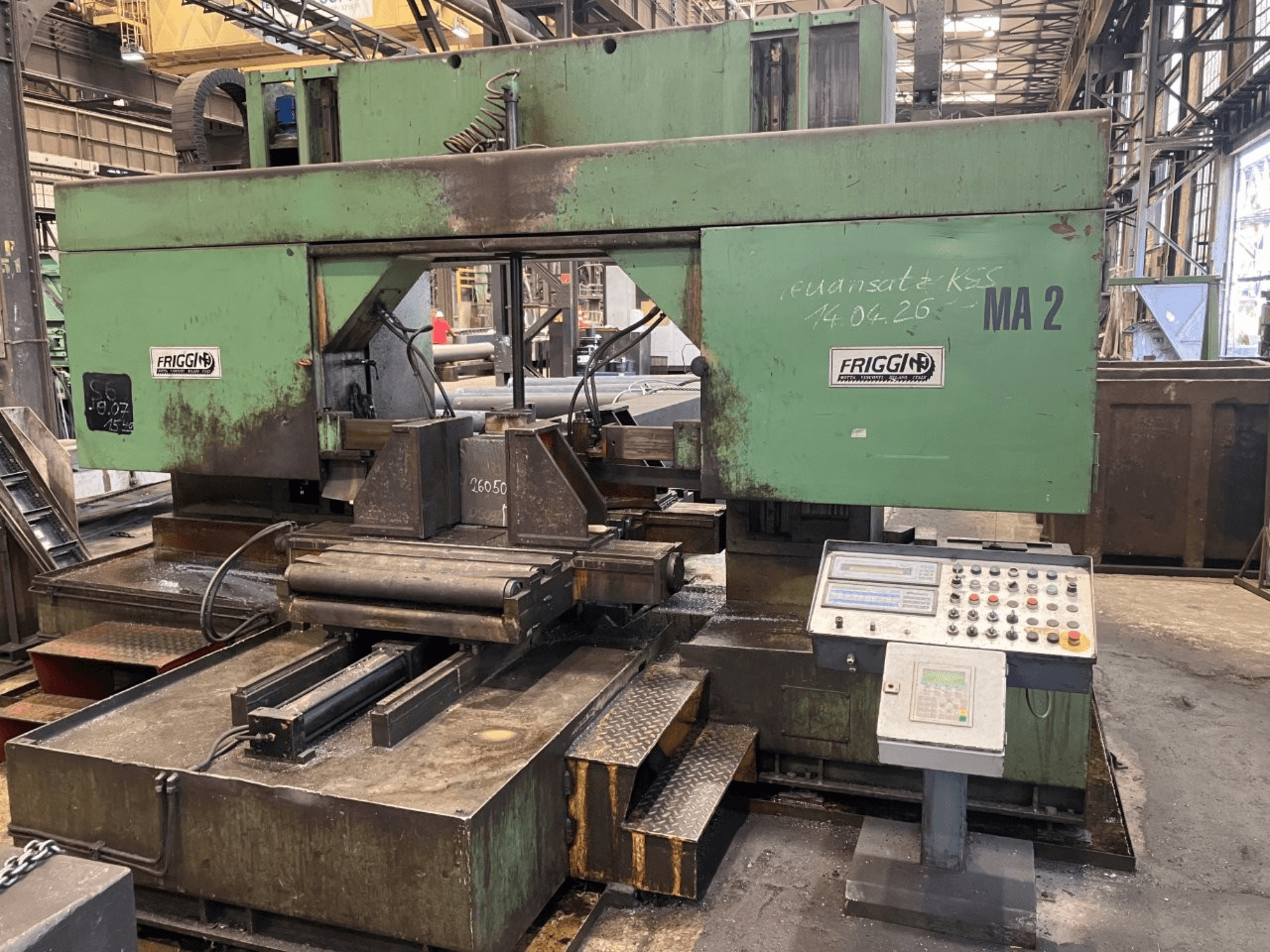 Friggi 2MF/AUT metal band saw, front view showing control panel, bladed section, and table setup in a workshop environment.
