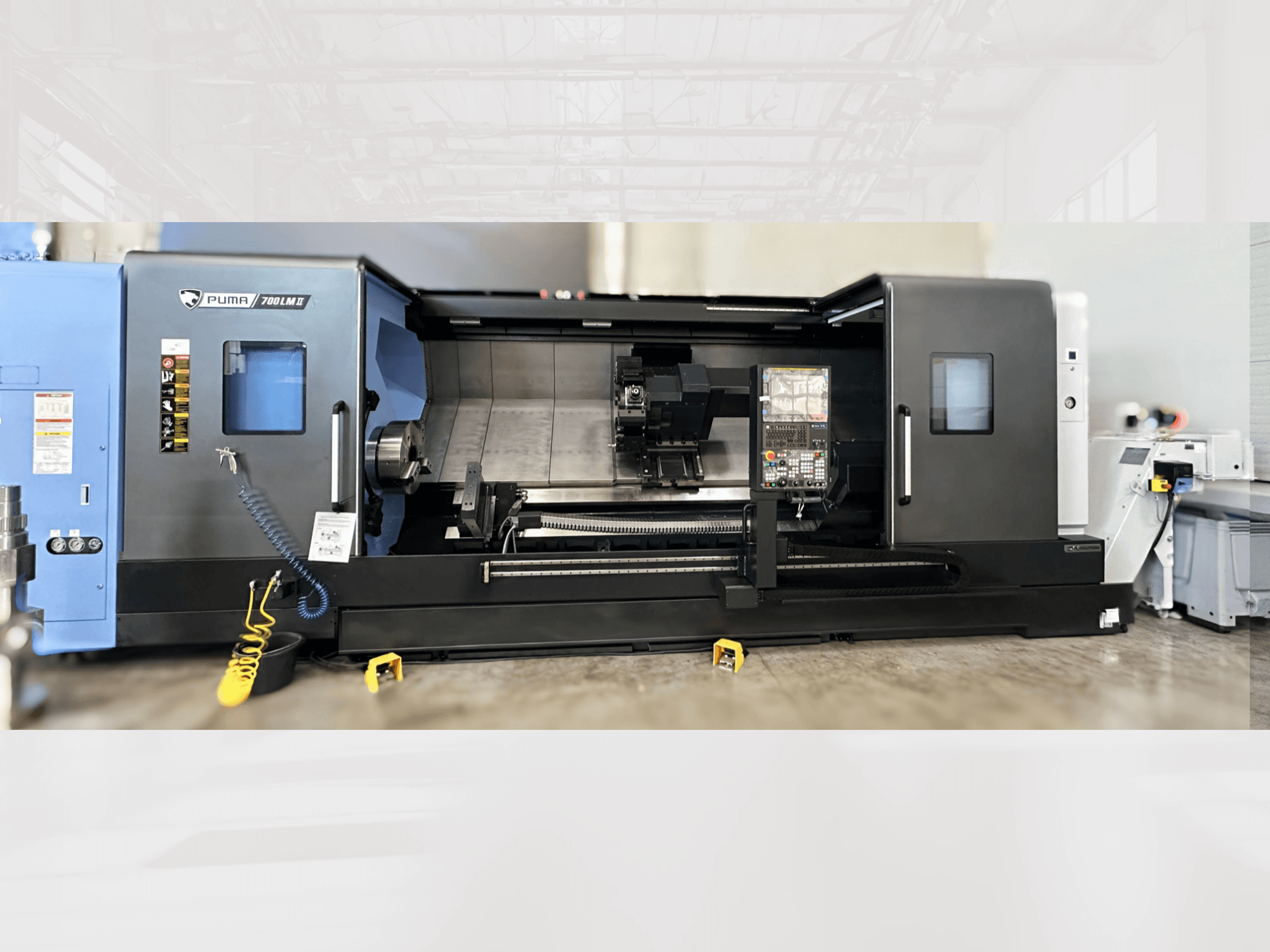 DN SOLUTIONS PUMA 700LM Turn-Mill Centre, front view, showcasing control panel and machining area with visible tools.