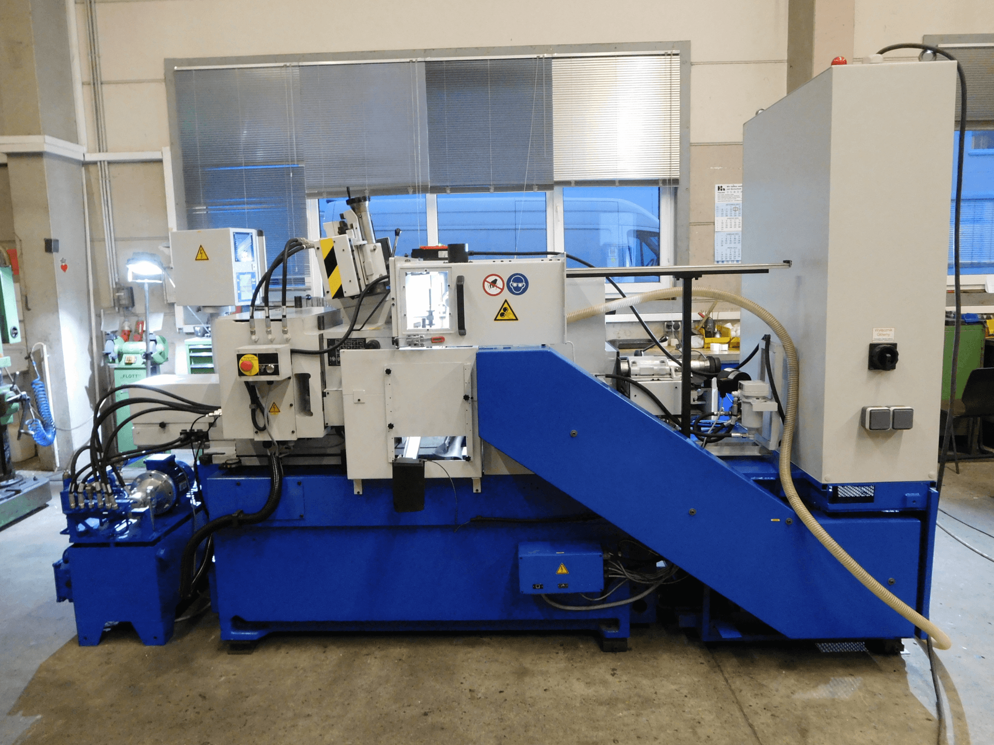 Schaudt Mikrosa SASL 125 centerless grinding machine, side view, with blue base and control panel, showcasing operational features.