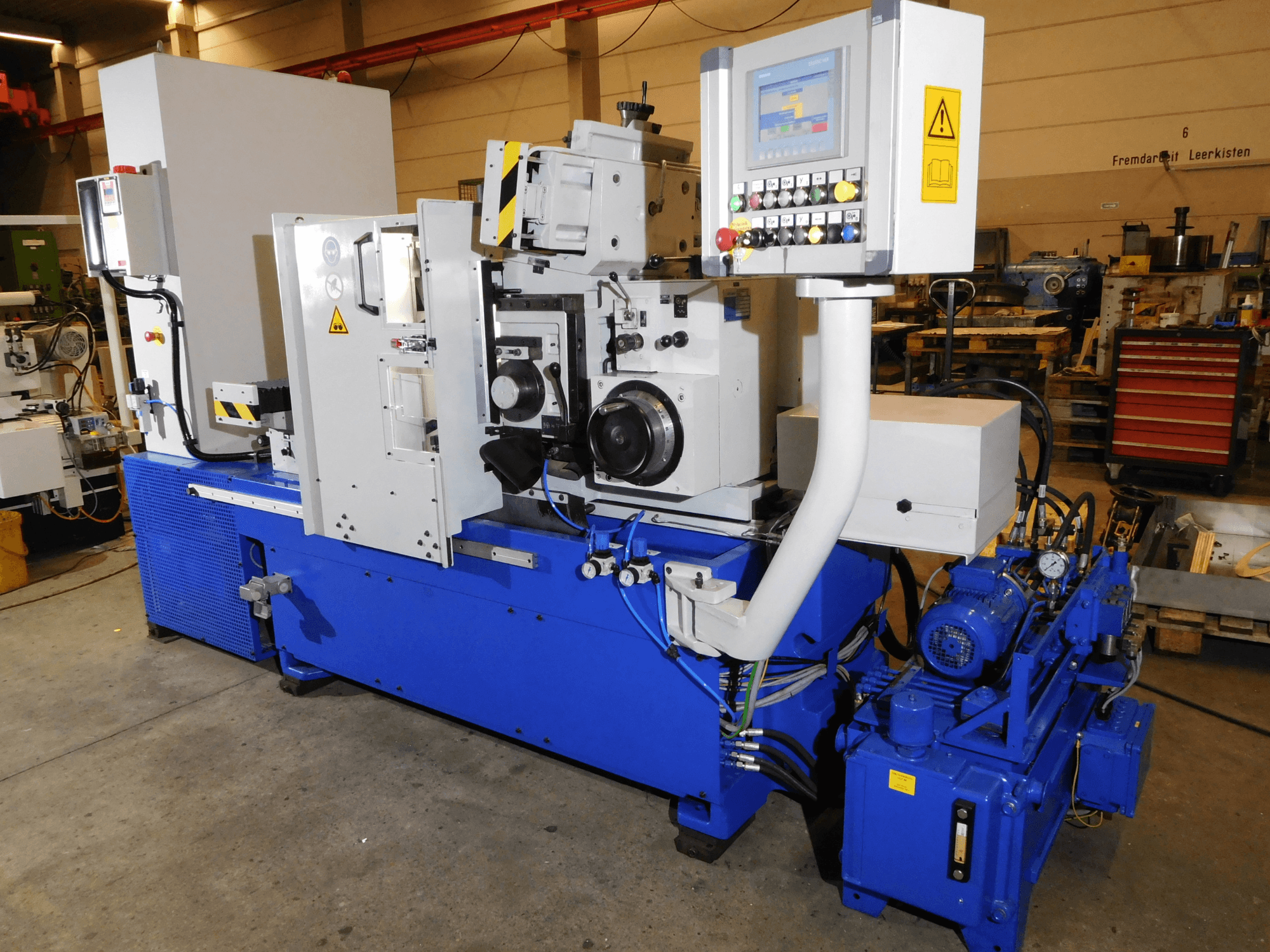 Schaudt Mikrosa SASL 125 centerless grinding machine, side view, featuring controls and industrial blue body with motor components.