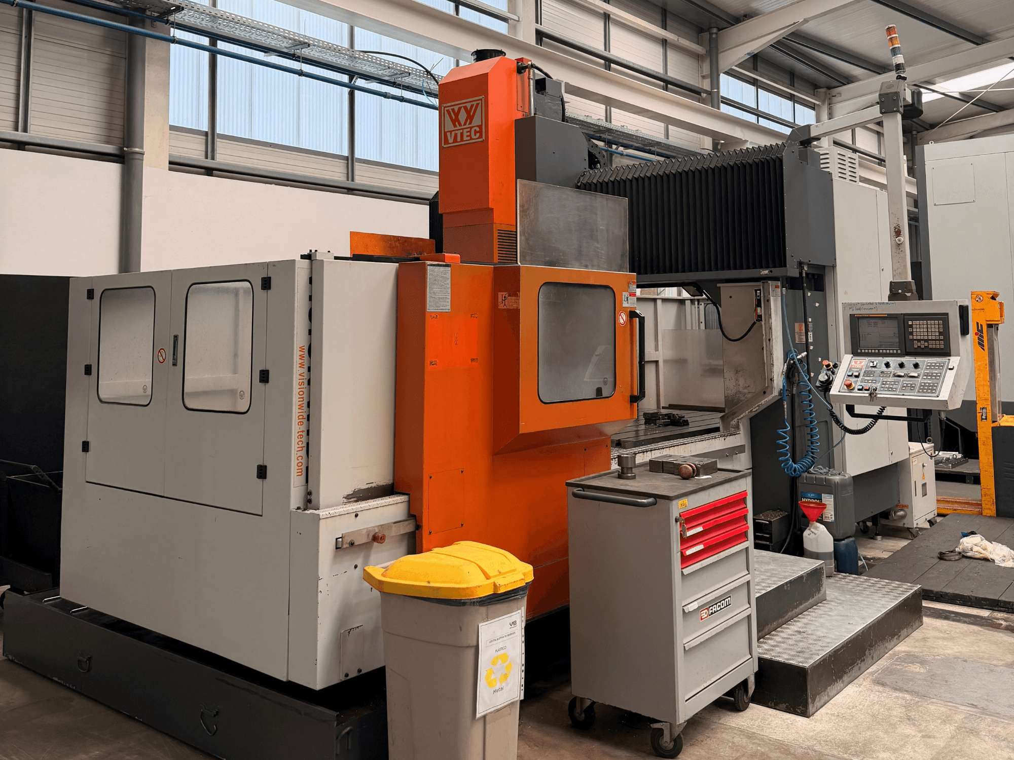Gantry milling machine Vision Wide Vision, front view, showcasing controls, cabinet, and tool storage in a workshop setting.
