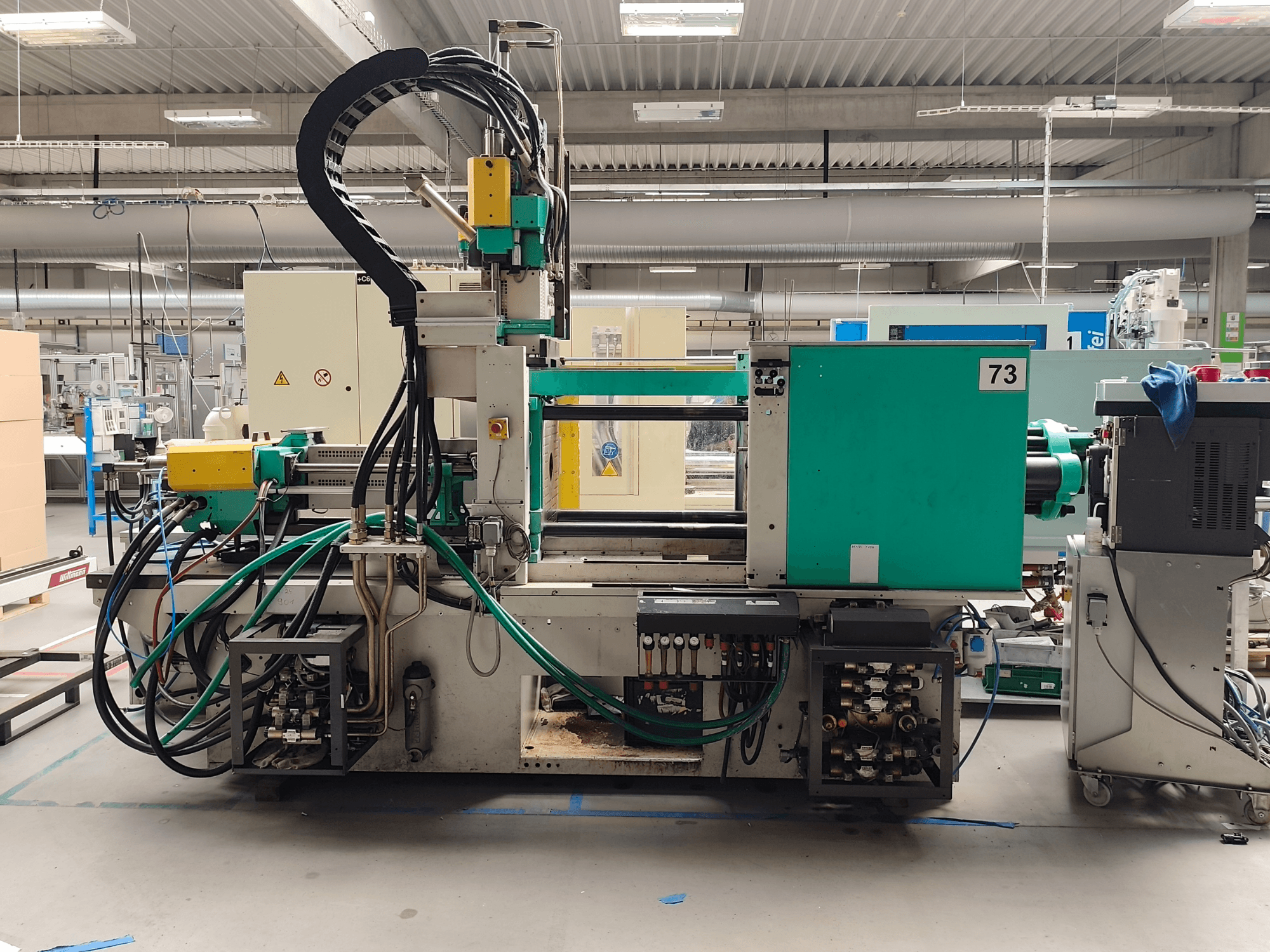 Hydraulic injection moulding machine, Arburg 420 C 1000-150/60, side view, with visible hydraulic connections and operational controls.