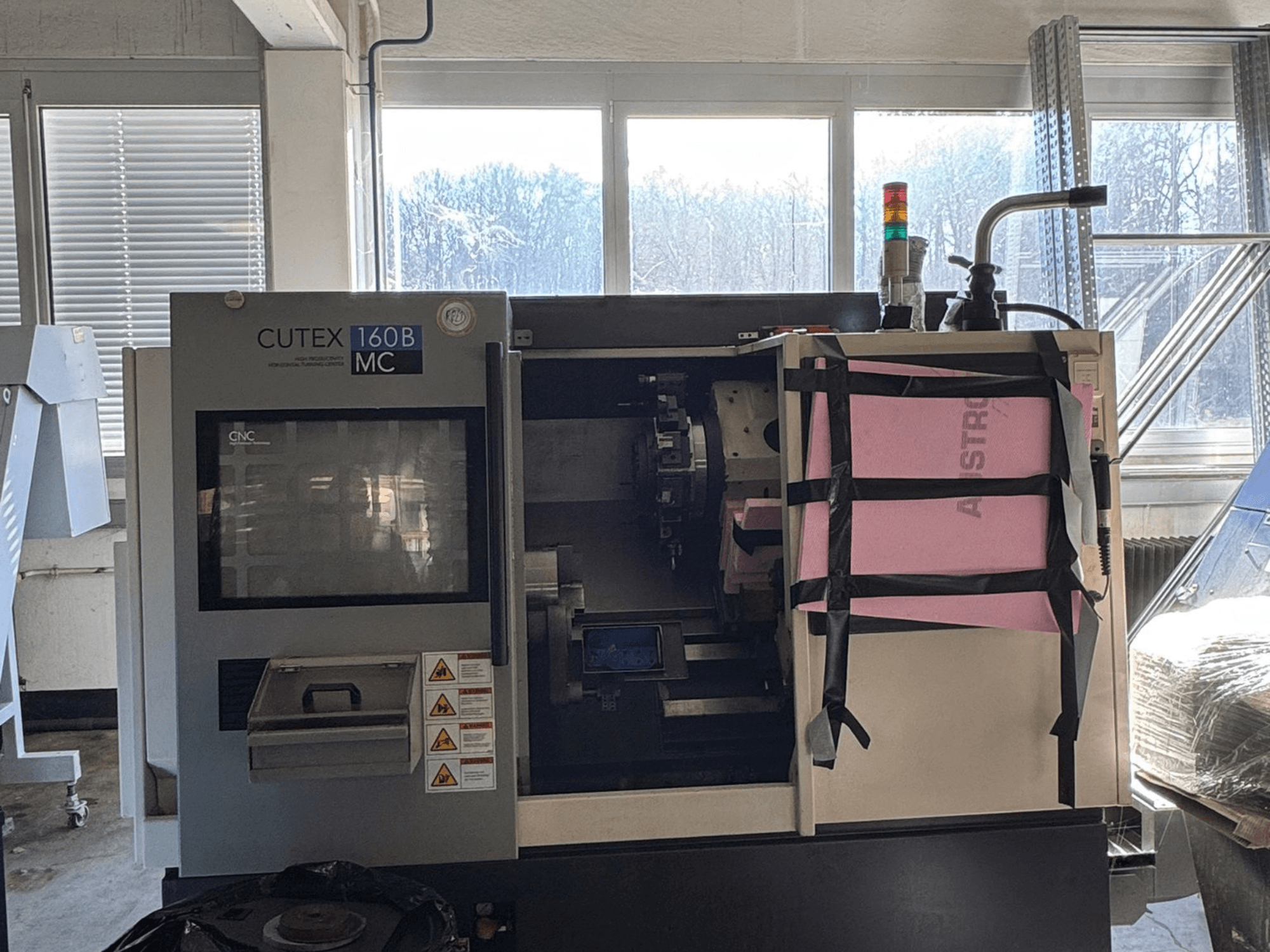 Front view of HWACHEON CUTEX 160 B VDI horizontal turning machine with control panel and coolant tank, featuring a safety light.