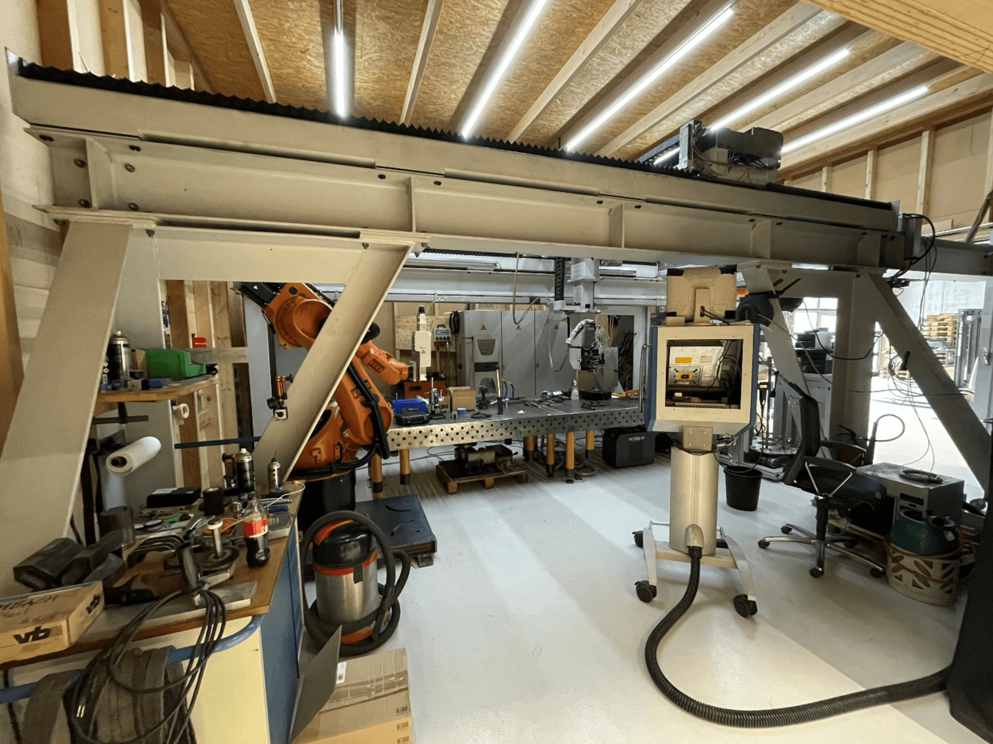 Stiefelmayer Laserhärtenanlage machine tool, front view, showcasing robotic arm and control panel in a workshop setting.