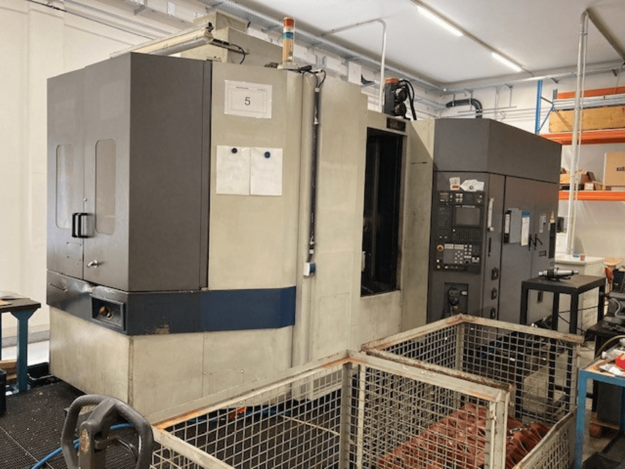 MORI SEIKI SH633 horizontal machining center, front view, showcasing control panel and safety features.