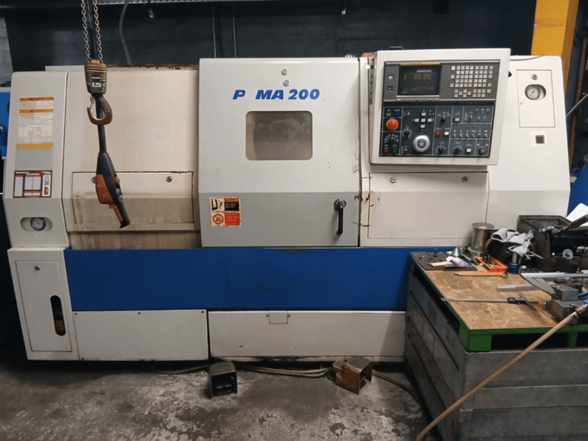 DAEWOO EcoTurn 200 horizontal turning machine front view, featuring control panel and safety labels.