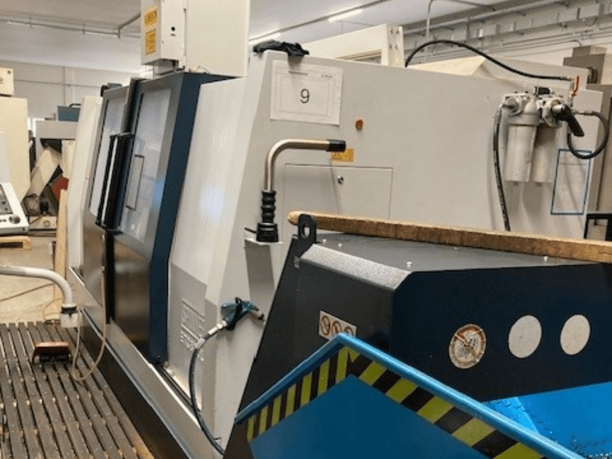 SPINNER TC800L 110 Horizontal Turning Machine viewed from the side, showcasing control panel and safety features.