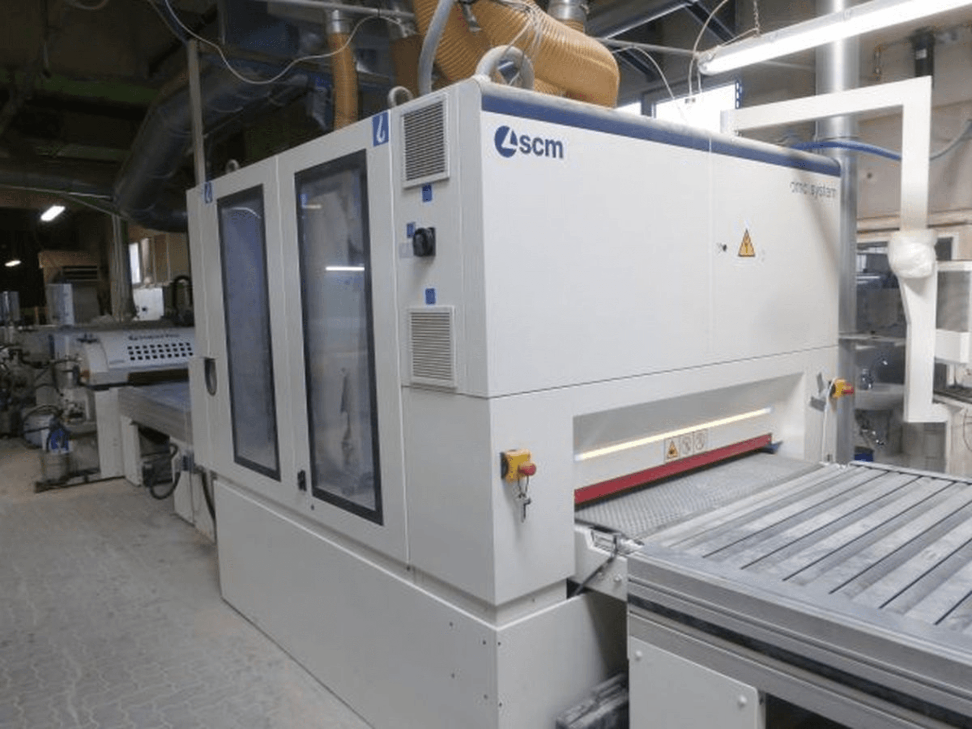 Alt text: Front view of a SUPERFICI Valiorta F1 B wood processing machine with transparent doors and visible control panel.