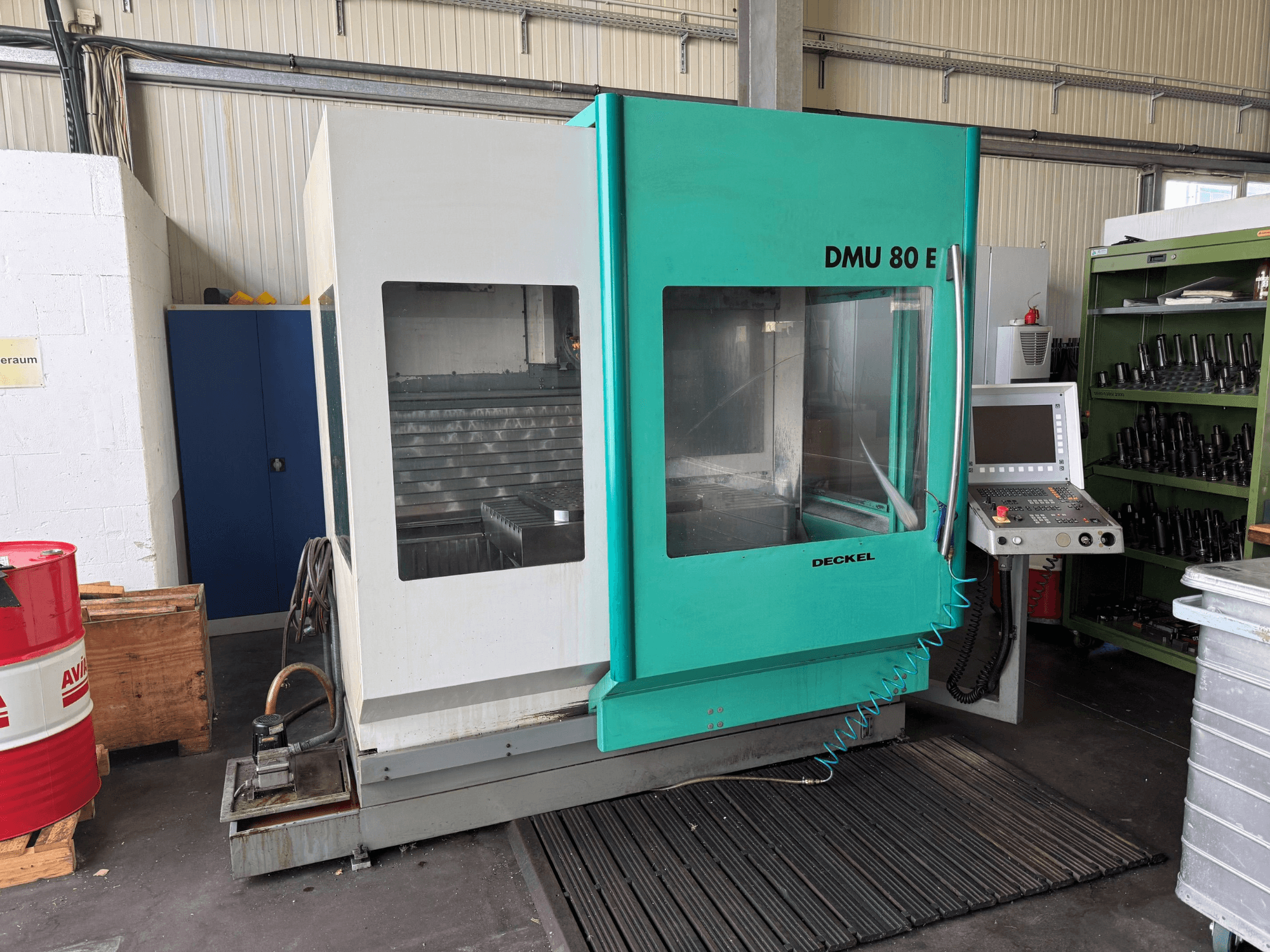Front view of the DECKEL DMU 80 E vertical machining centre, showcasing control panel and work area.