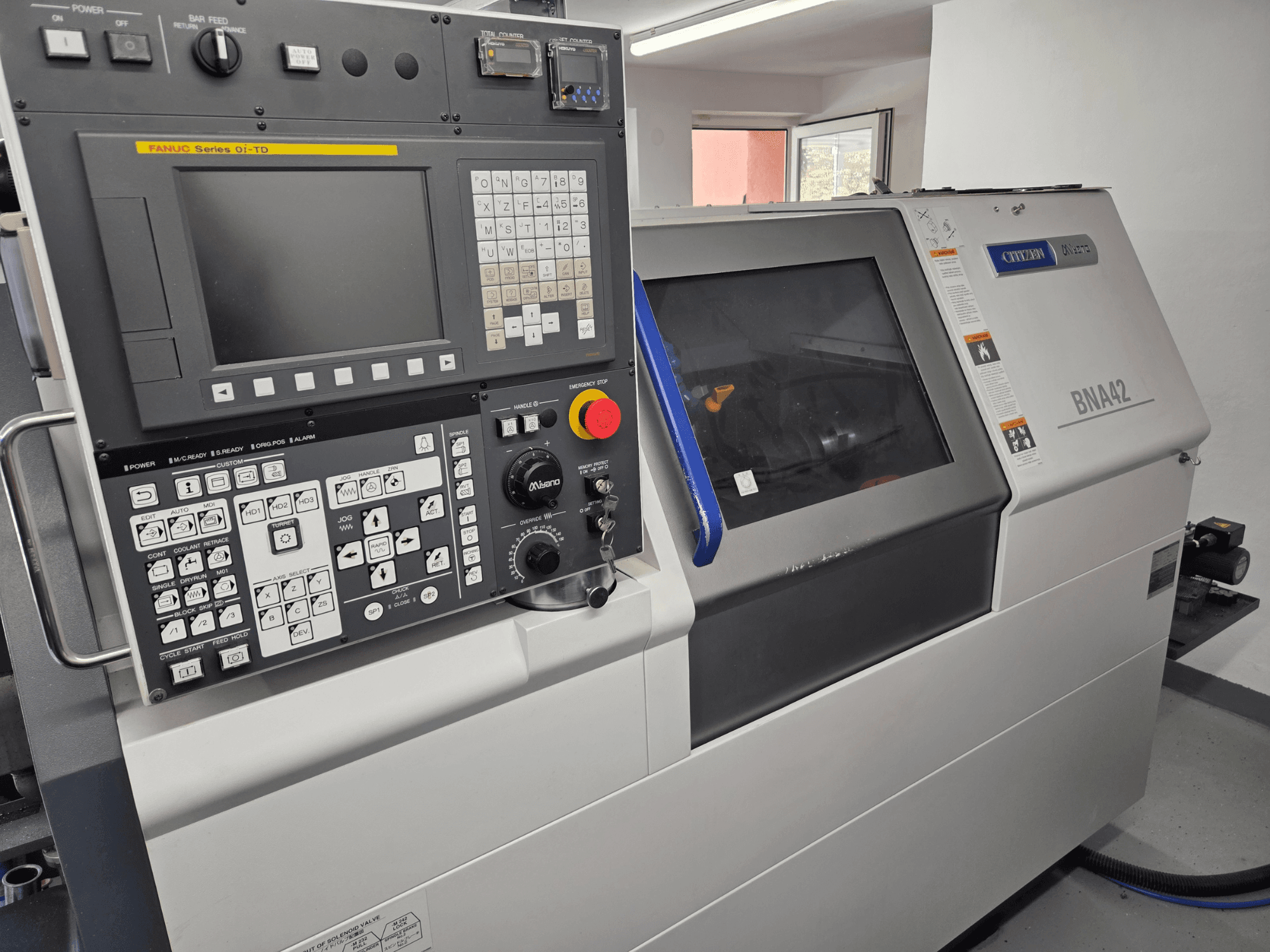 Miyano BNA42S2 horizontal turning machine, front view showing control panel with FANUC Series Oi-TD interface and display.