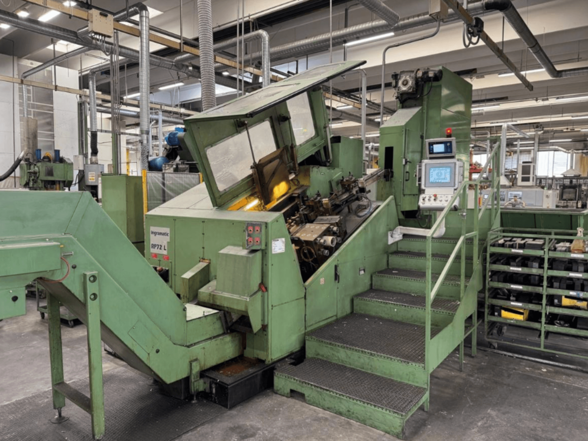 Ingramatic RP72 L, industrial machine in green, front view; features a control panel and steps with a metal grate platform.