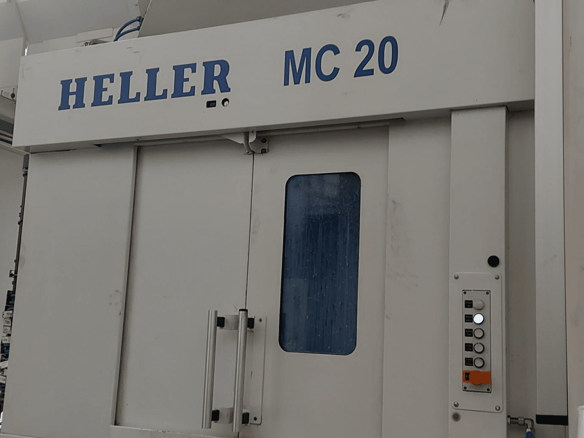 Front view of HELLER MC 20 Horizontal Machining Centre showing control panel and front window.