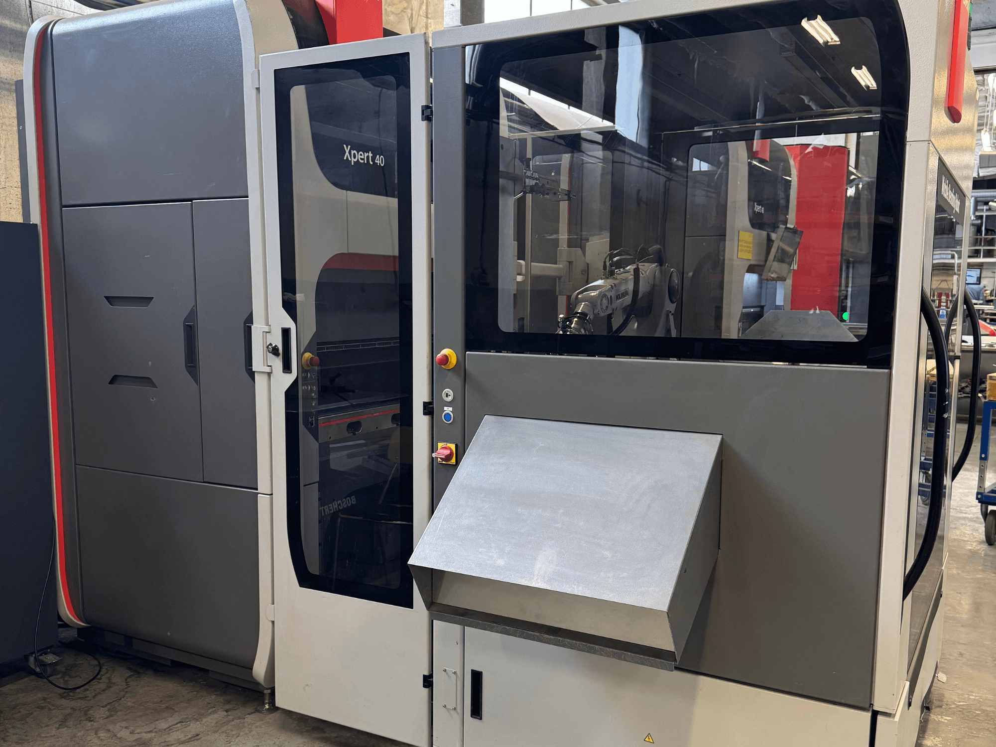 Bystronic Xpert 40/1030 press brake in front view, showcasing control panel, glass enclosure, and clean design features.