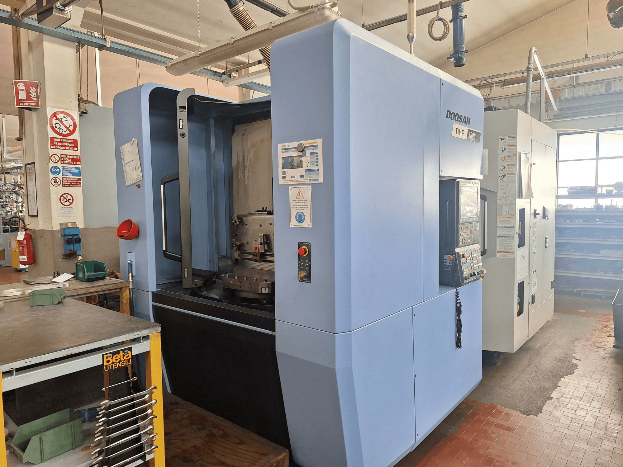 DOOSAN NHP 5000 Horizontal Machining Centre in a workshop, side view showcasing its control panel and machining area.