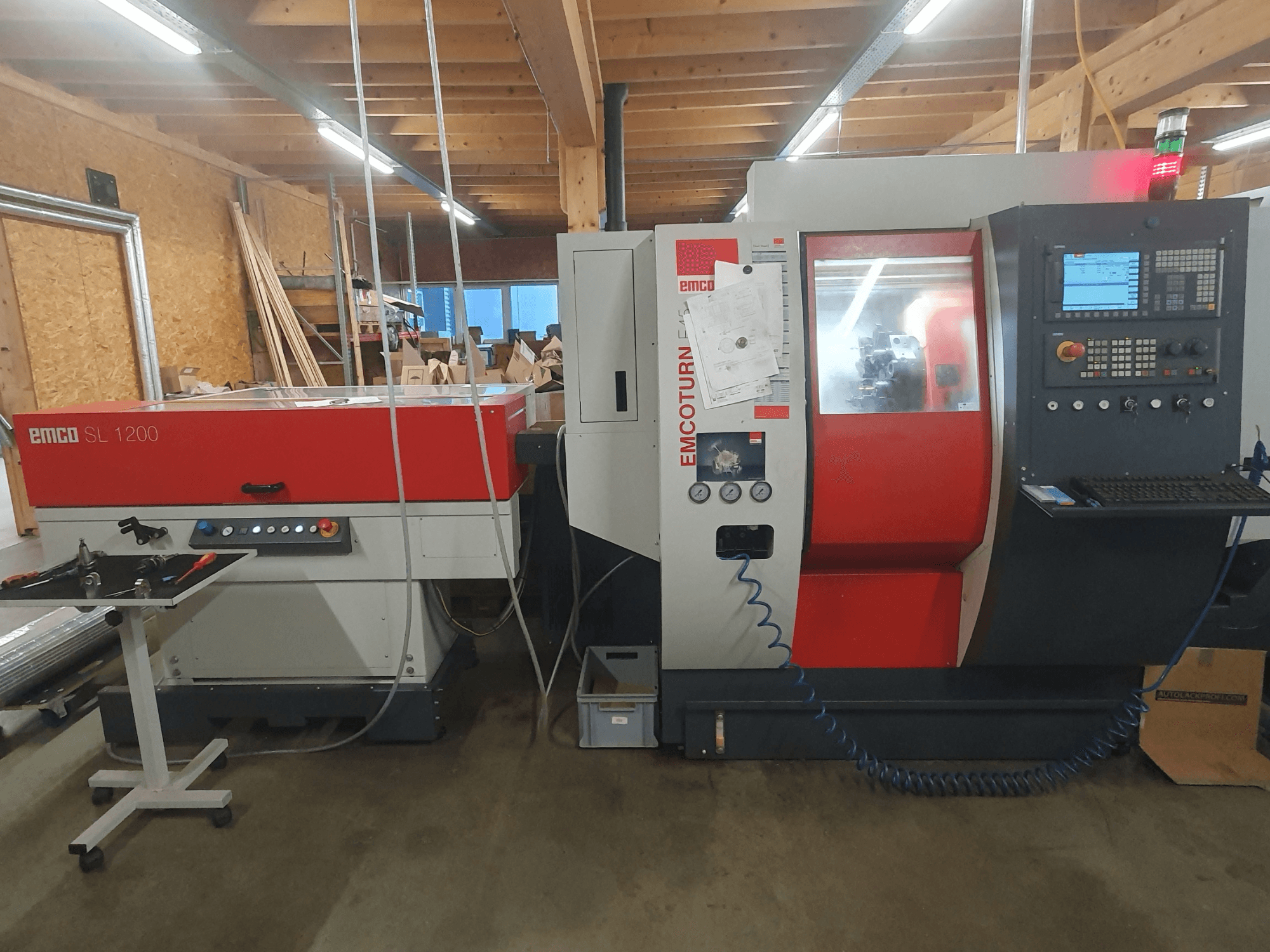 EMCO SL 1200 CNC lathe and EMCOturn; front view showing controls, displays, and operational indicators in a workshop setting.