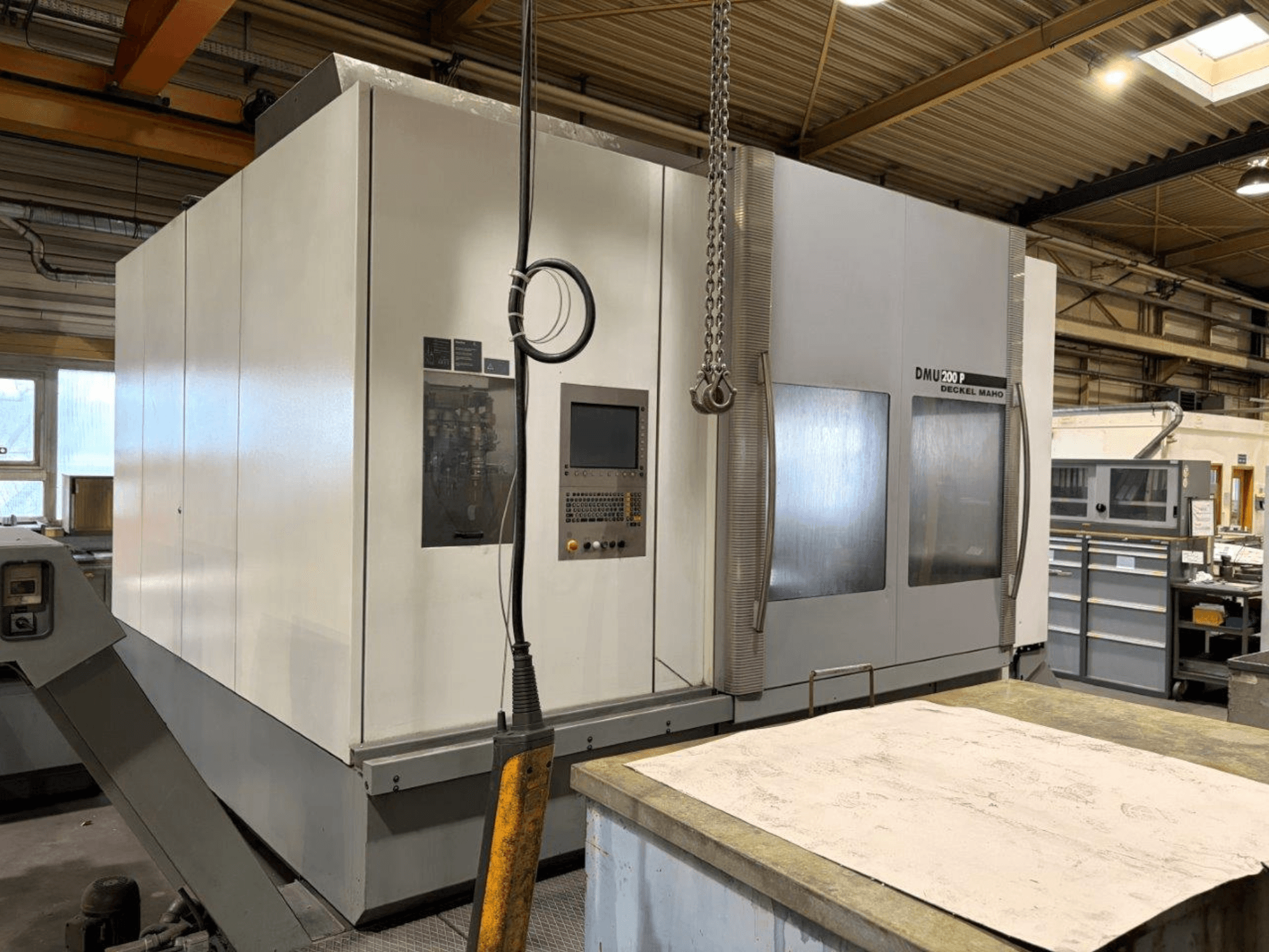 DMG MORI DMU 200 universal machining centre in a workshop, front view, showcasing its control panel and exterior features.