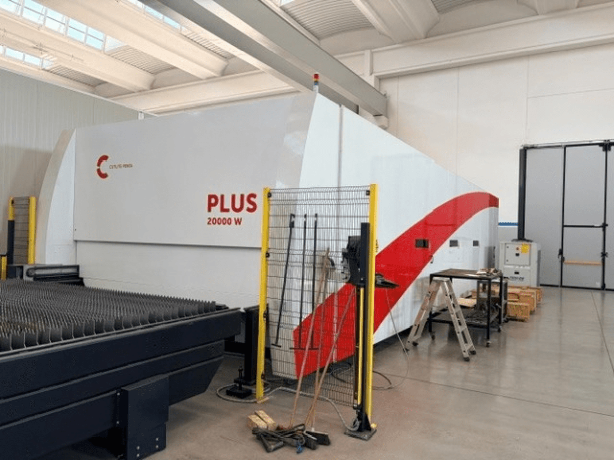 CUTLITE PENTA PLUS LM 9030 fiber laser cutting machine, side view, showing 20000 W power, with protective fencing and workspace.