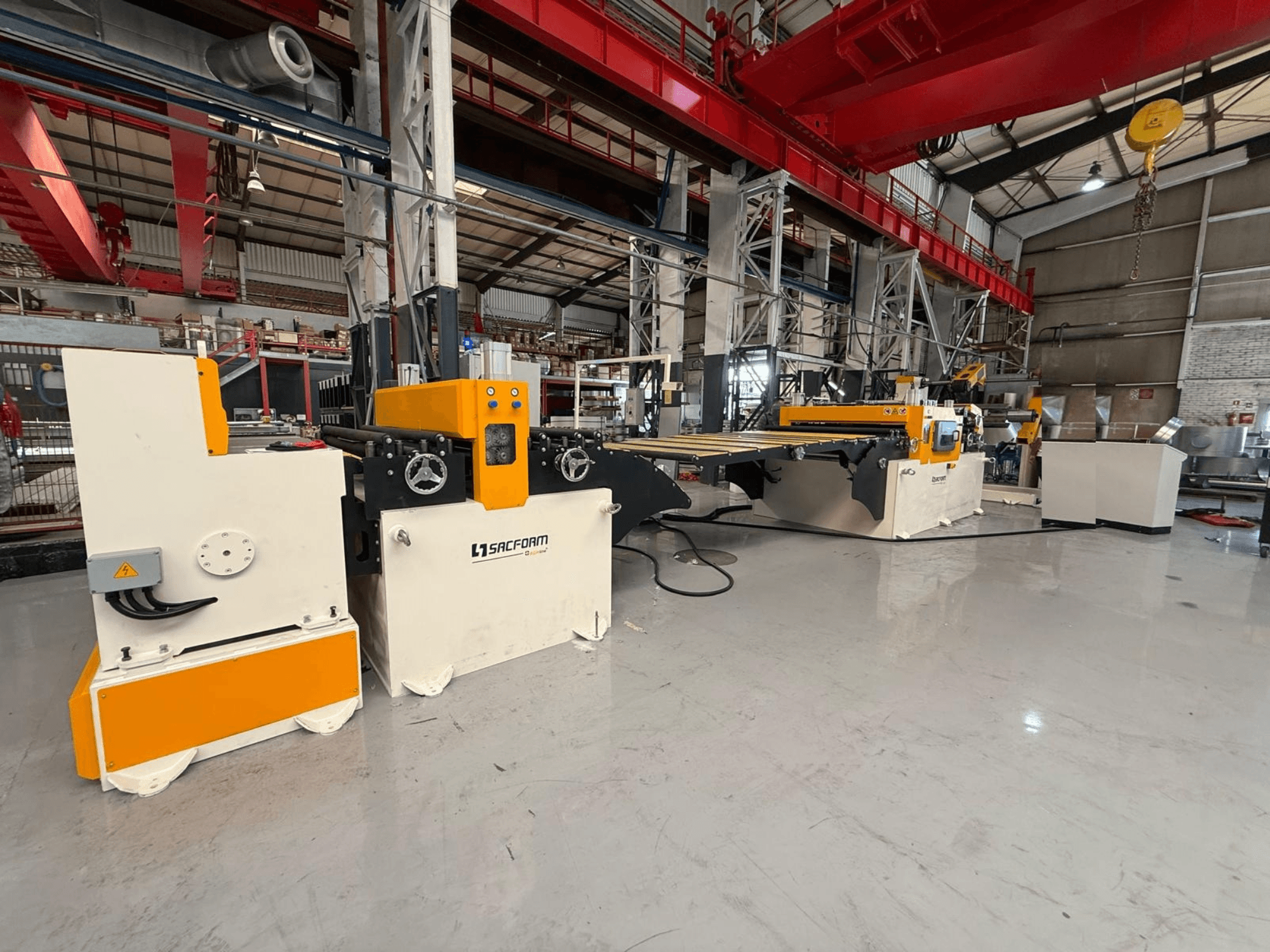 Front view of SACFORM CRL1503-6 sheet metal machine, featuring a yellow and white design, wheels, and operational controls.