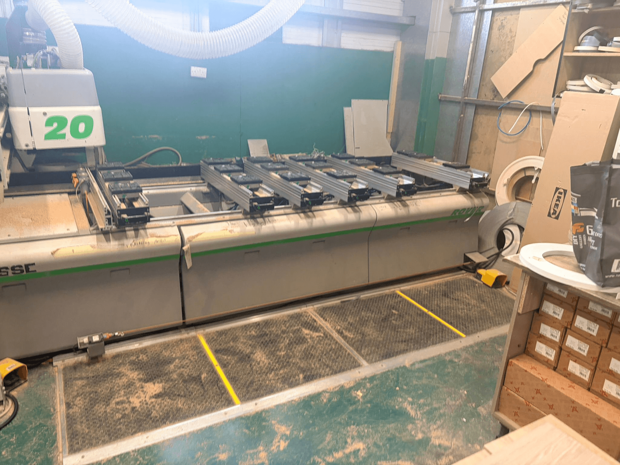 CNC wood machining centre BIESSE ROVER 20, front view, with rail system, controls, and sawdust visible on the surface.