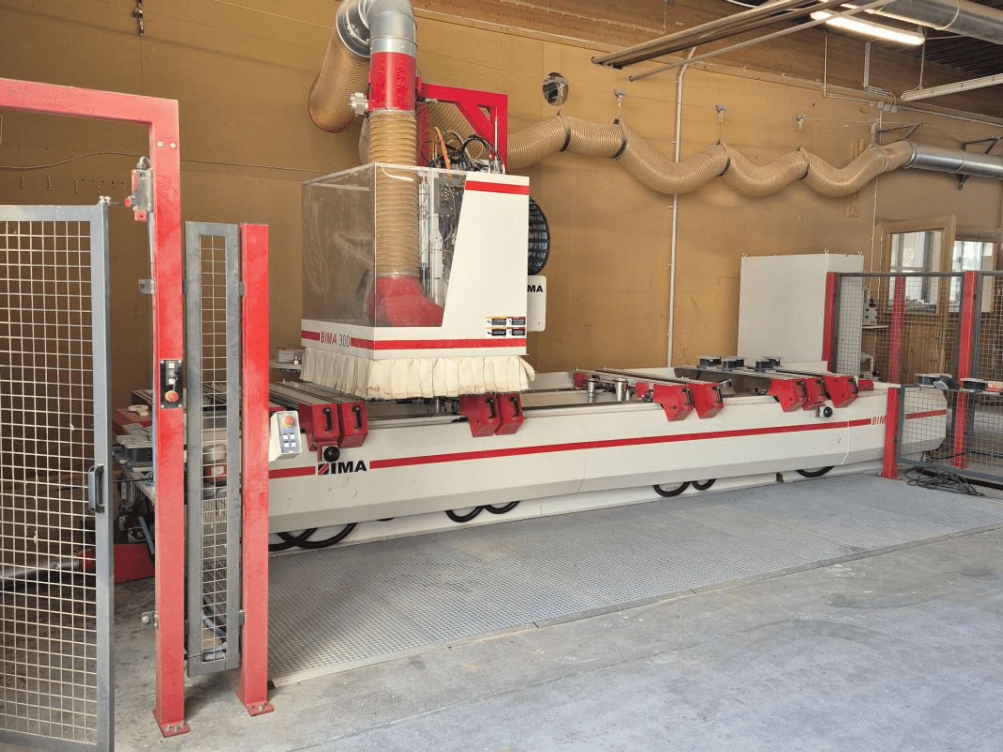 CNC Processing Center IMA BIMA/300/125/530 in a workshop, front view with red accents and safety enclosure.