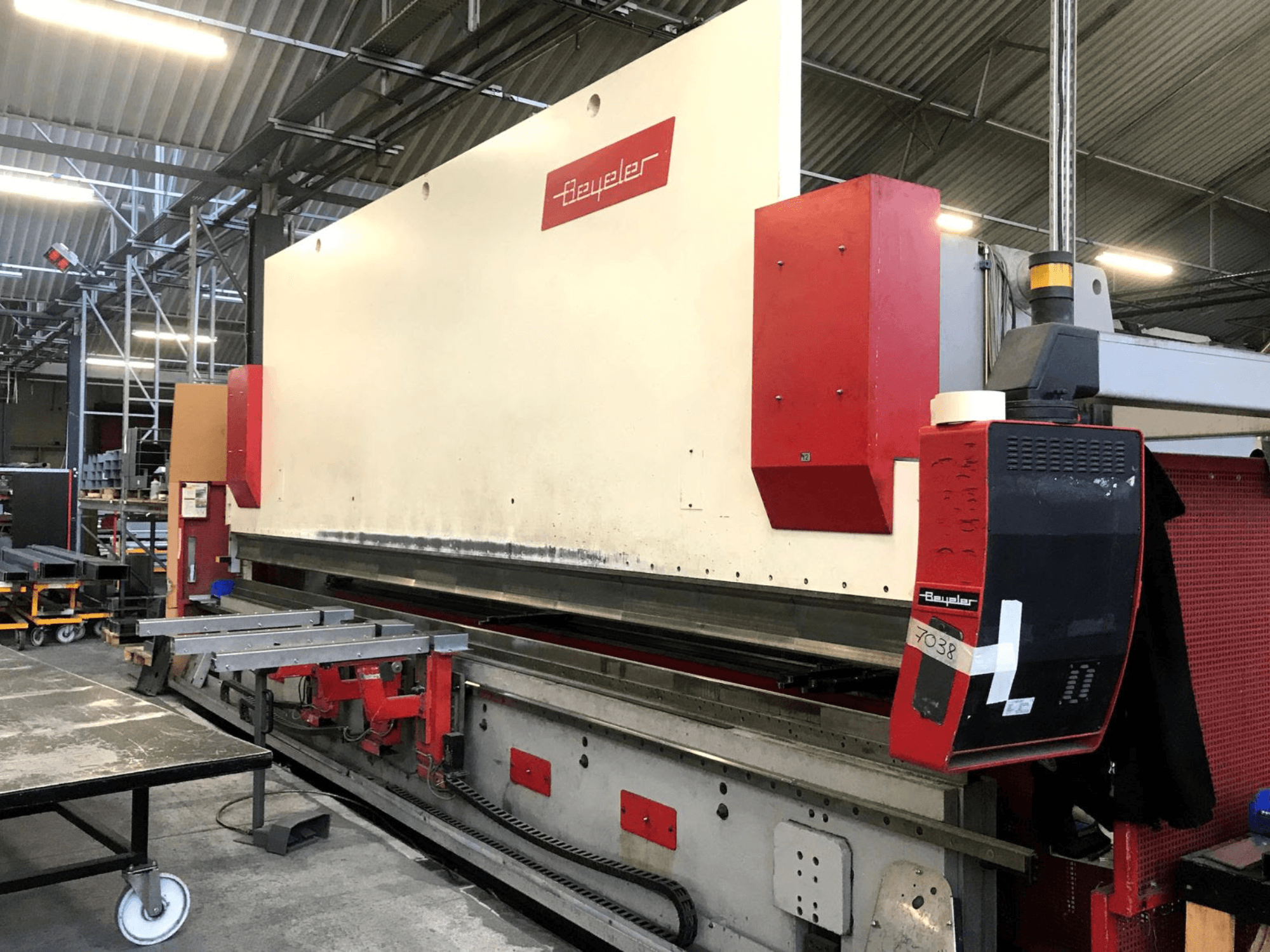 BEYELER PR-10 press brake, front view, showcasing control panel and metalwork table in a workshop setting.